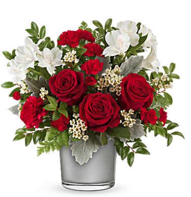 Midnight Kiss - A classic expression of love, Teleflora's Midnight Kiss Bouquet pairs lush red roses and white blooms in a sleek silver vase with a polished, modern glow. It's the perfect way to make any moment feel timeless and romantic. Features red roses, red carnations, miniature red carnations, white alstroemeria, and white waxflower, accented with dusty miller, huckleberry, and leatherleaf fern. Presented in the Silver Polished Gem Cylinder, an elegant keepsake with a modern metallic finish. 
