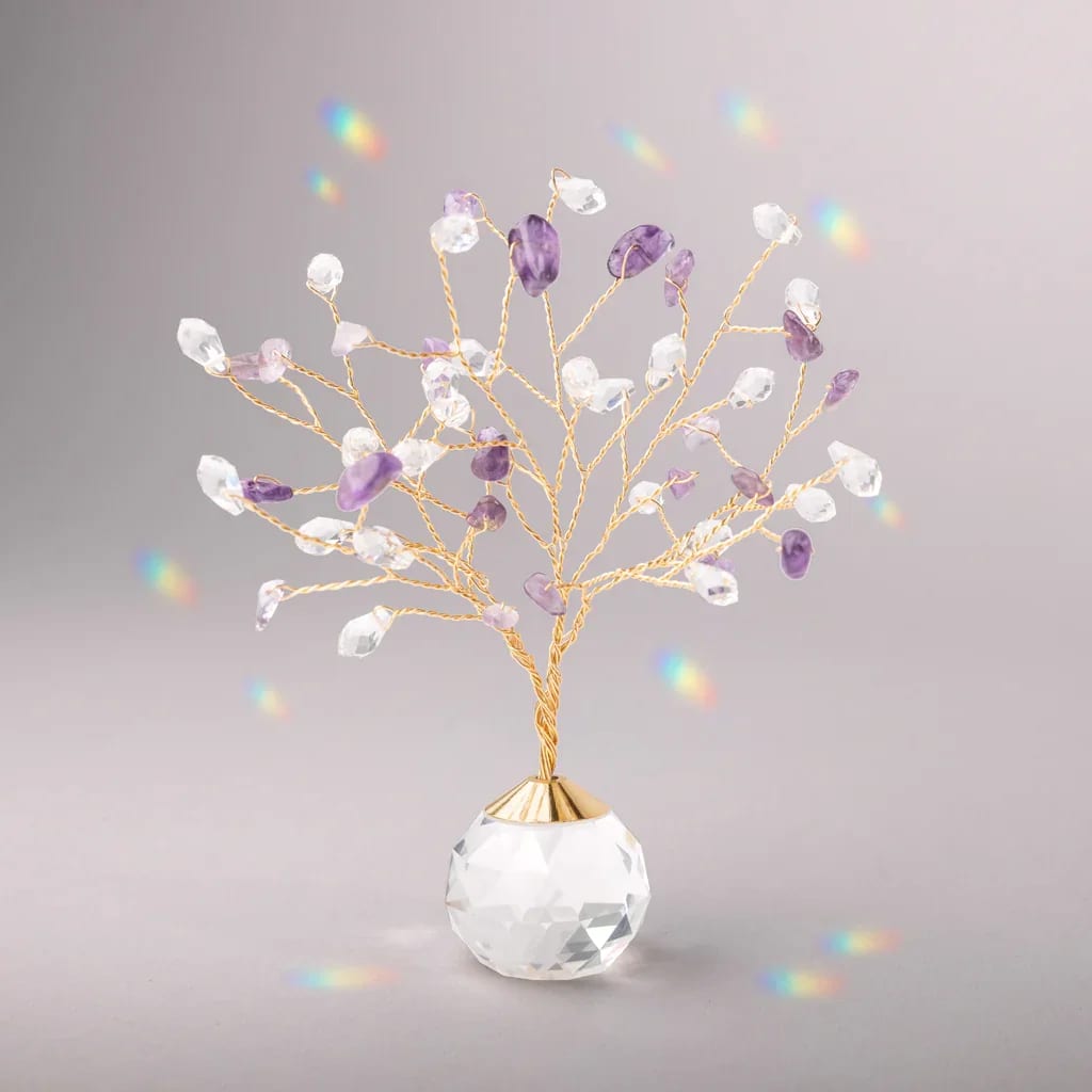 Small gold wire tree with clear and purple crystals on a faceted crystal base
