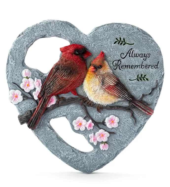 Heart-shaped gray memorial plaque with two cardinals and pink blossoms reading "Always Remembered".