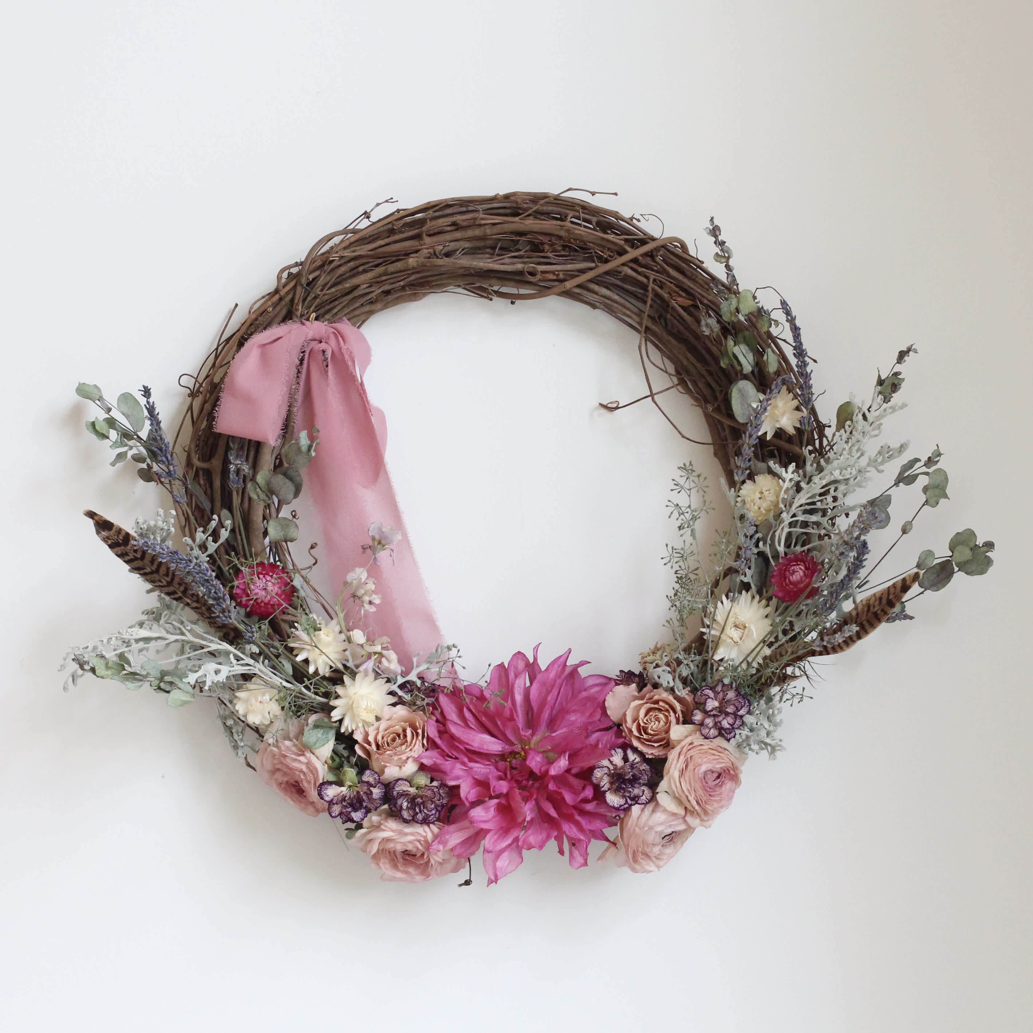Floral wreath with pink ribbon and mixed pink and white flowers