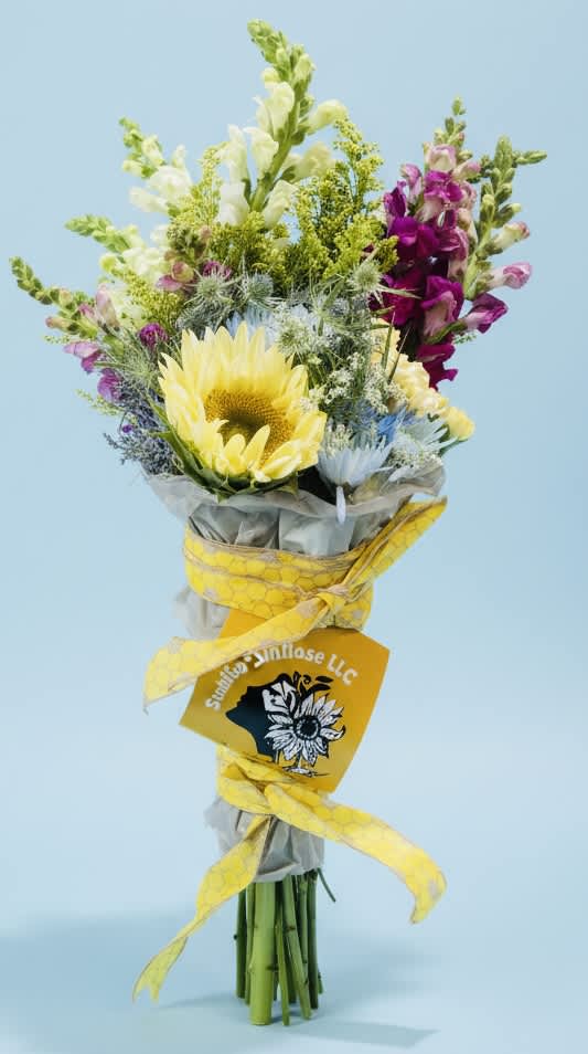 Bouquet with a yellow sunflower and purple snapdragons wrapped in yellow ribbon
