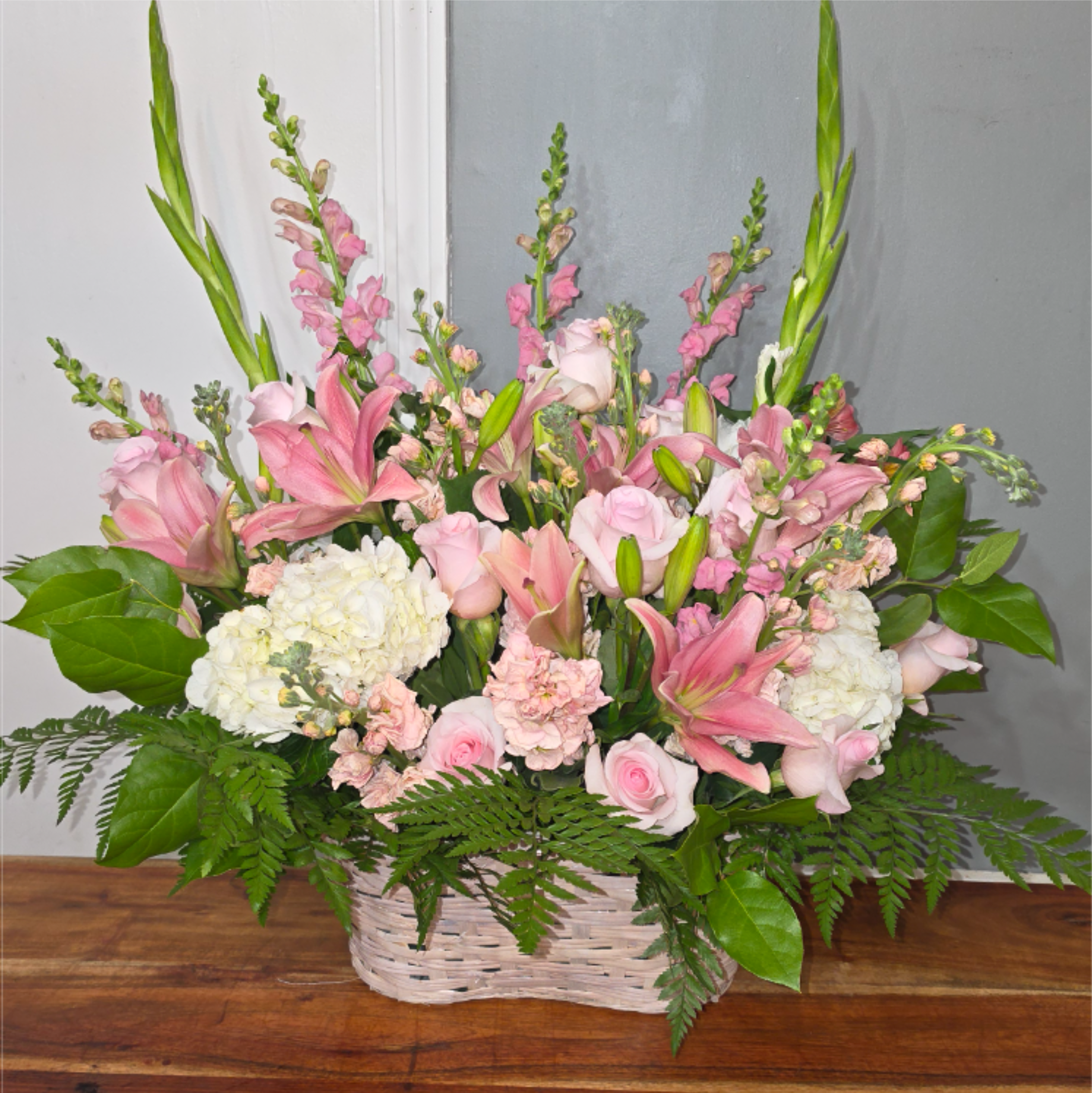 Pink Sky - Gorgeous pink and white arrangement with white hydrangea,  pink roses, pink lillies, and other pink flowers in a white basket.