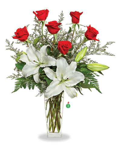Red roses and white lilies in a clear glass vase