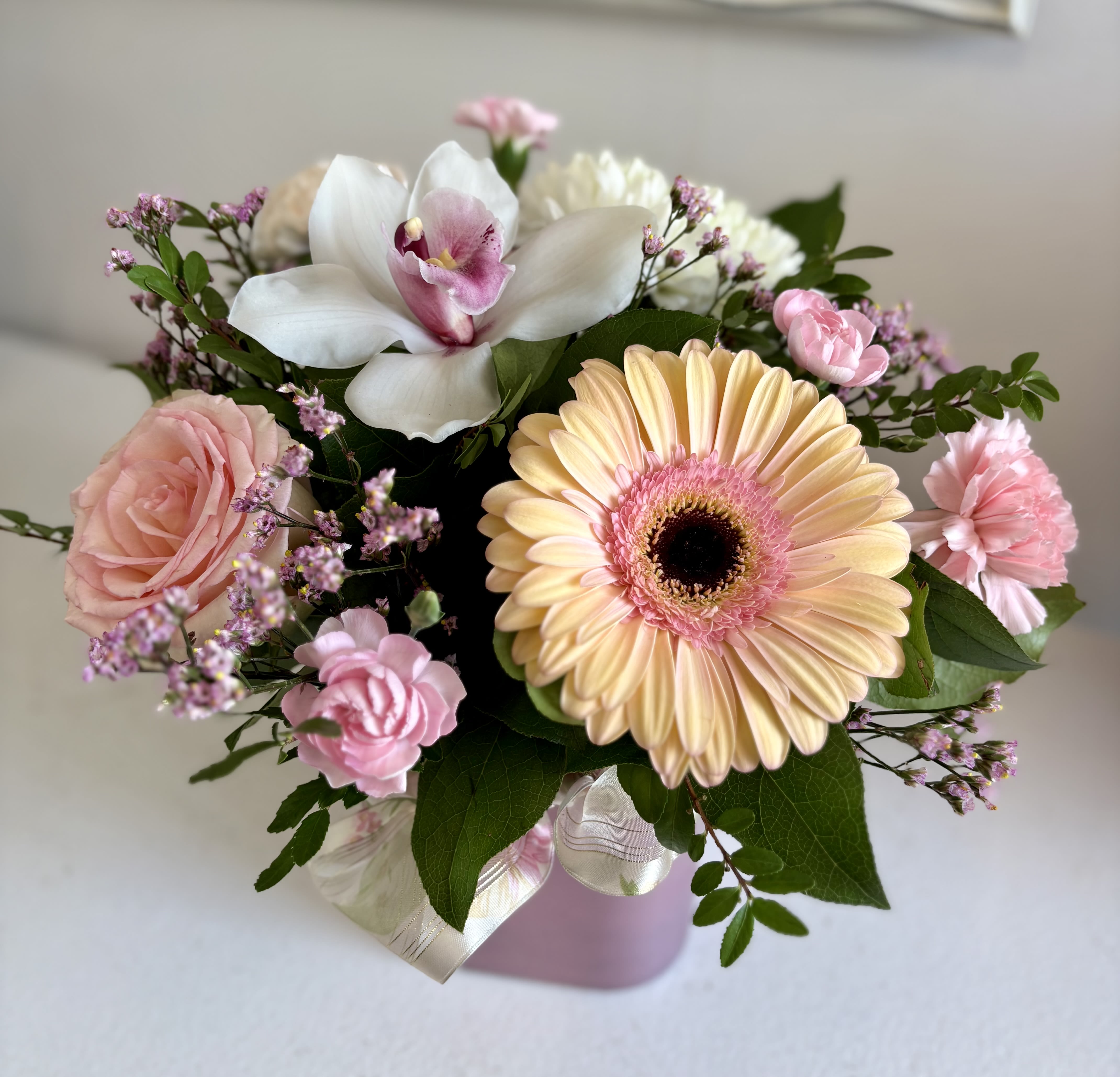Blush Serenity  - A cube arrangement with a soft blush palette, thoughtfully structured yet naturally flowing. It brings together delicate blooms creating a clean, modern form with a gentle romantic feel. The overall look is refined, warm, and quietly elegant.