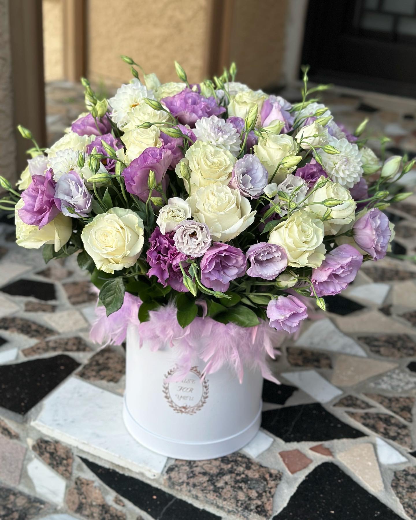 Whisper of spring -  А perfect blend of calm, tenderness, and refined beauty. White blooms symbolize purity and light, while lilac adds a touch of mystery, romance, and soft daydreaming. Together, they create a harmonious mood that suits both special occasions and heartfelt gestures “just because.”  Neatly arranged in a stylish box, this composition makes a lovely gift for a colleague, mother, friend, or someone you love. Flowers that speak gently — without words.