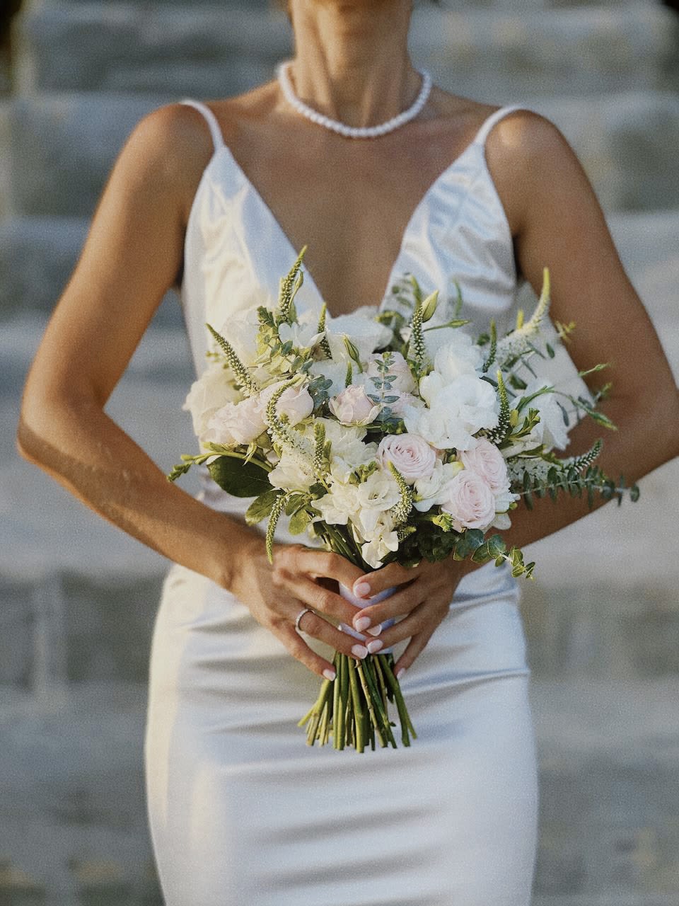 Bride holding a white and blush wedding bouquet