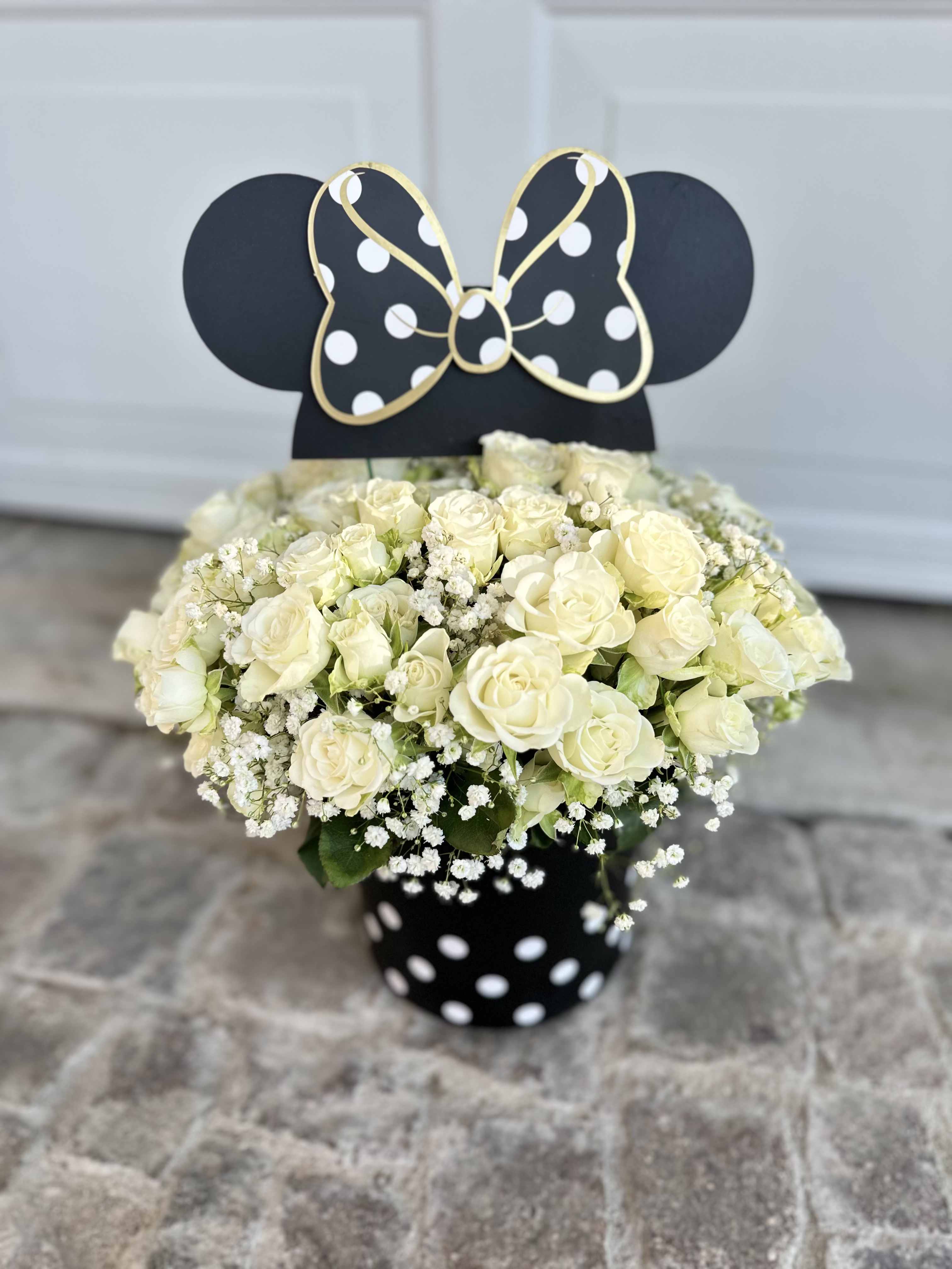 White rose bouquet in a black polka-dot vase with a Minnie Mouse topper