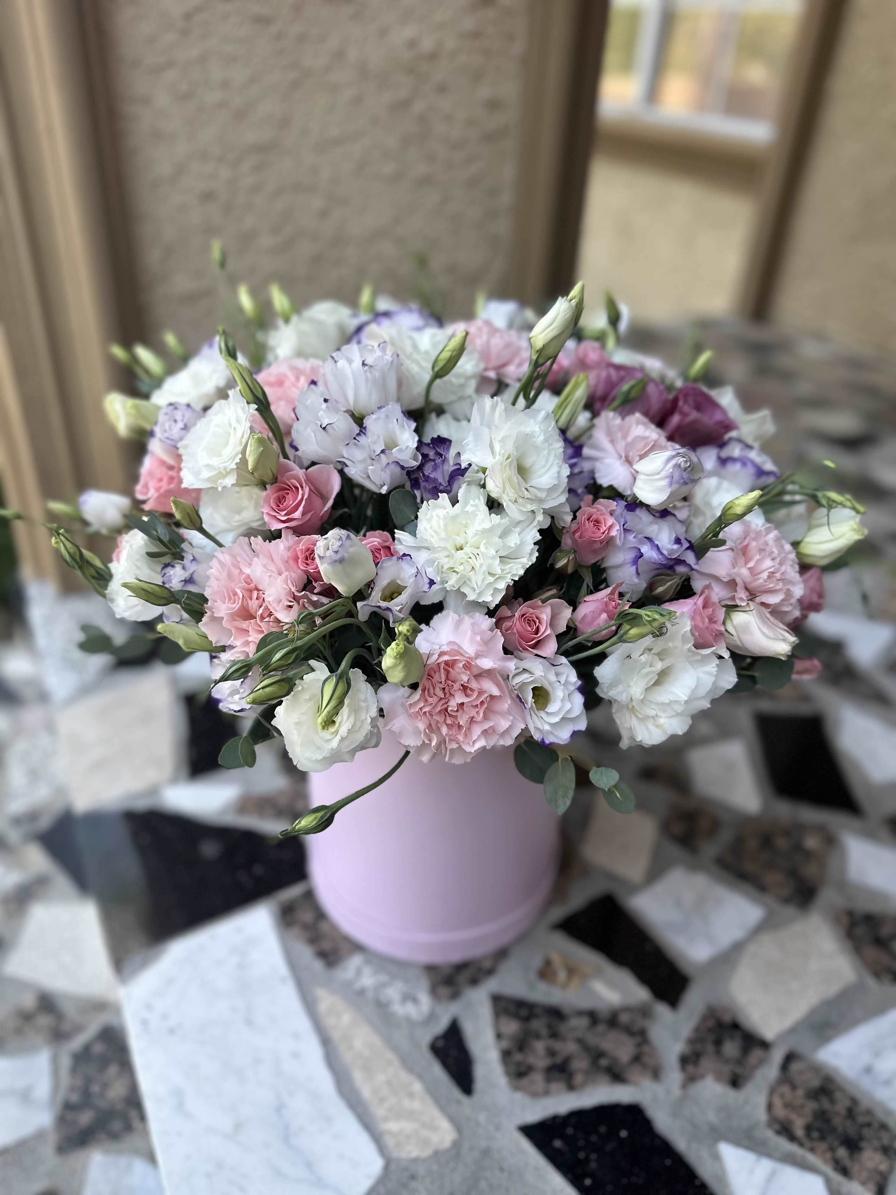Pink and white bouquet in a pastel pink hat box