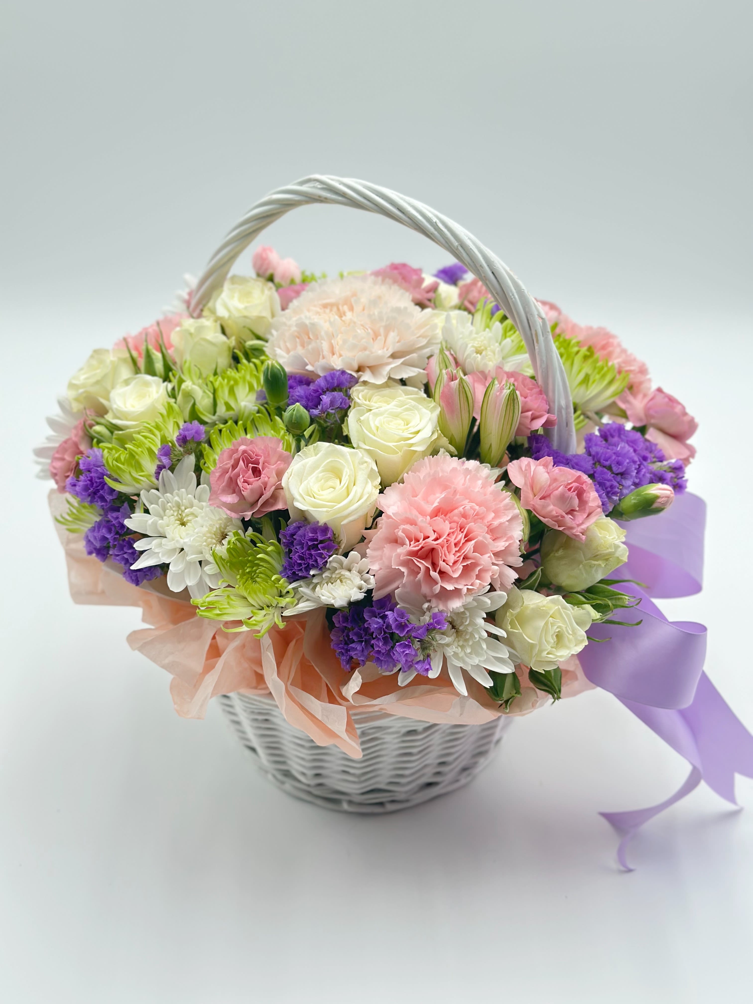 Mixed pastel flower basket with roses, carnations, and daisies