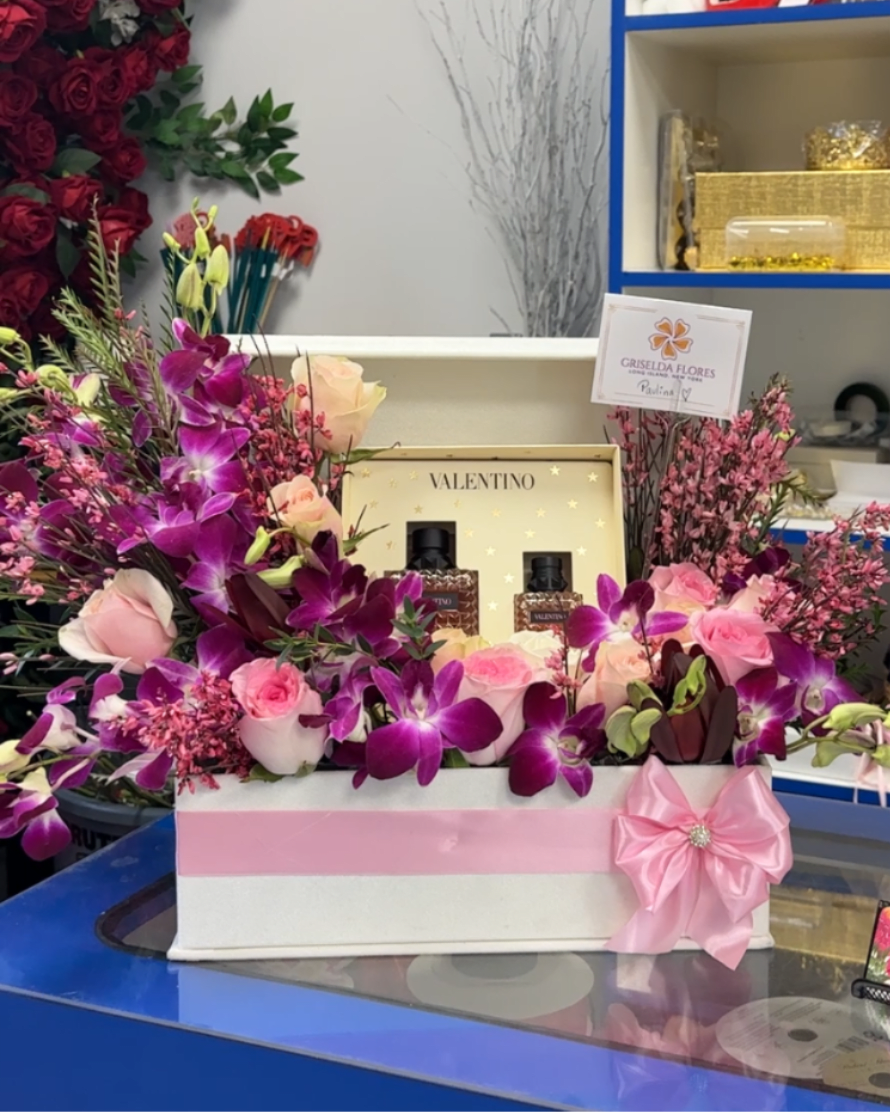 Pink and purple floral gift box with roses and orchids, plus perfume bottles