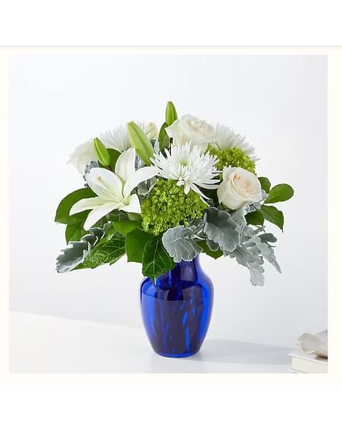 White flowers arranged in a blue glass vase