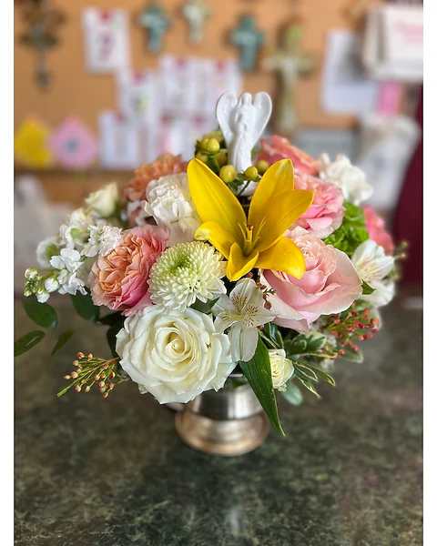 Mixed bouquet with a yellow lily and pink and white roses in a metal vase