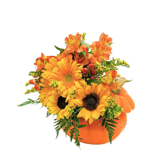 Orange and yellow floral arrangement in a pumpkin container