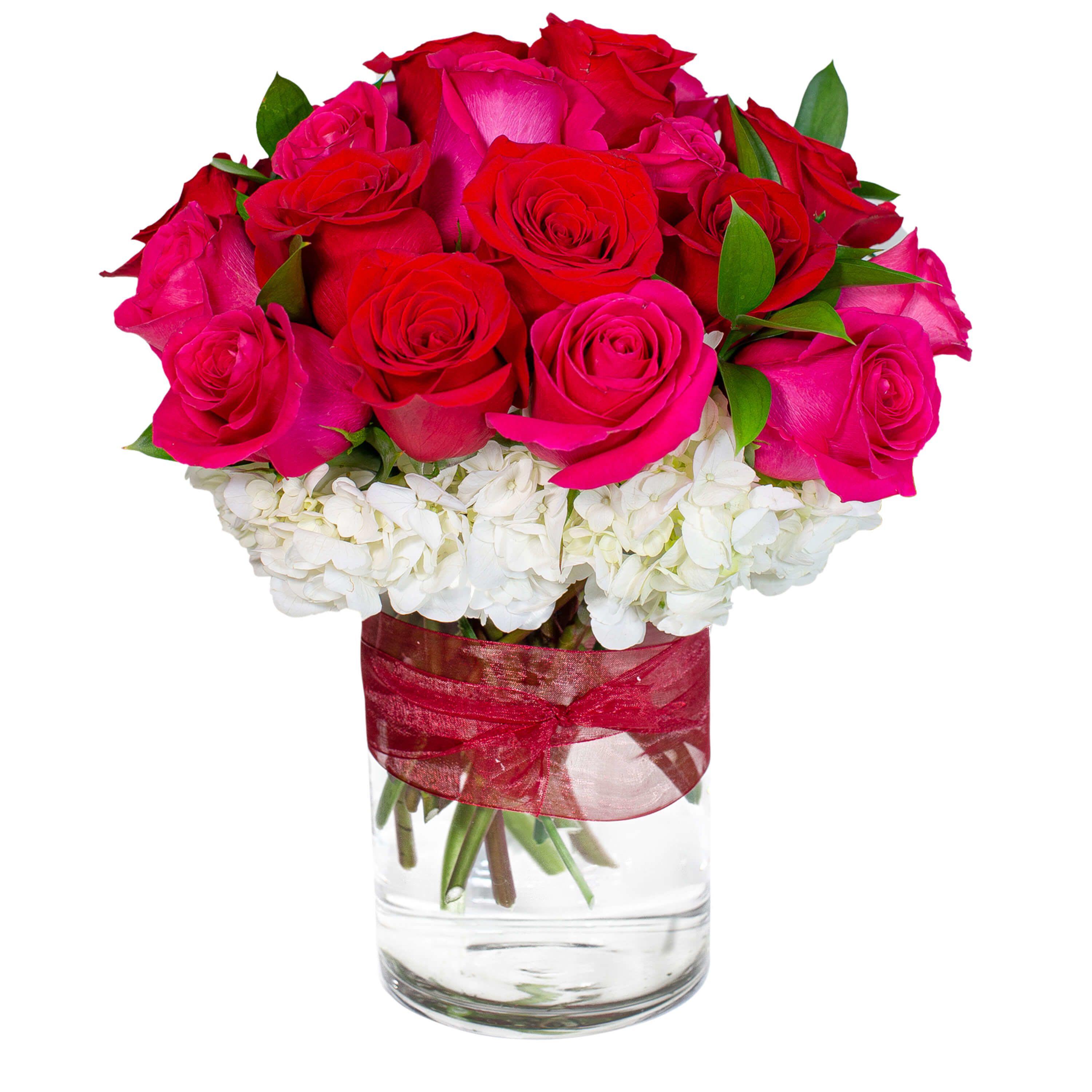 Hugs and Kisses - Wrap them in unconditional love. Hugs and Kisses lets them know you want to be wrapped in their arms. Hot Pink and Red Roses are paired in this beautiful expression of love.