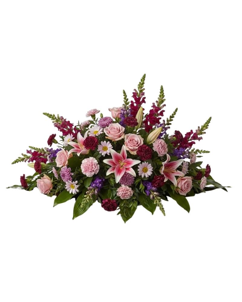 Eternal Grace Casket Spray  - An elegant and expansive horizontal display designed to rest gracefully atop a casket. This full, luxurious arrangement serves as a final, beautiful gesture, combining the delicate fragrance of lilies with the classic beauty of roses.