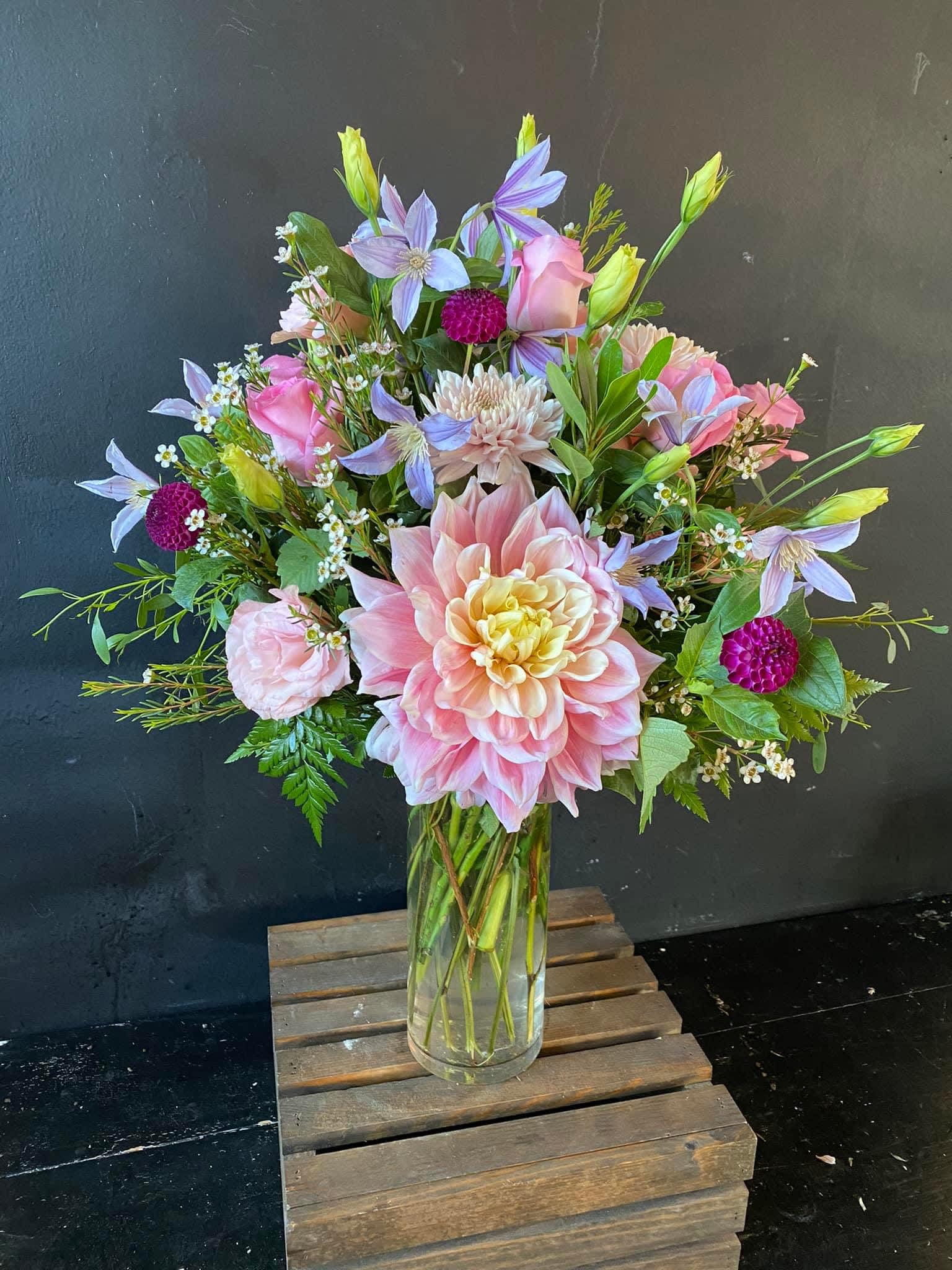 Pink and lavender mixed bouquet in a clear glass vase