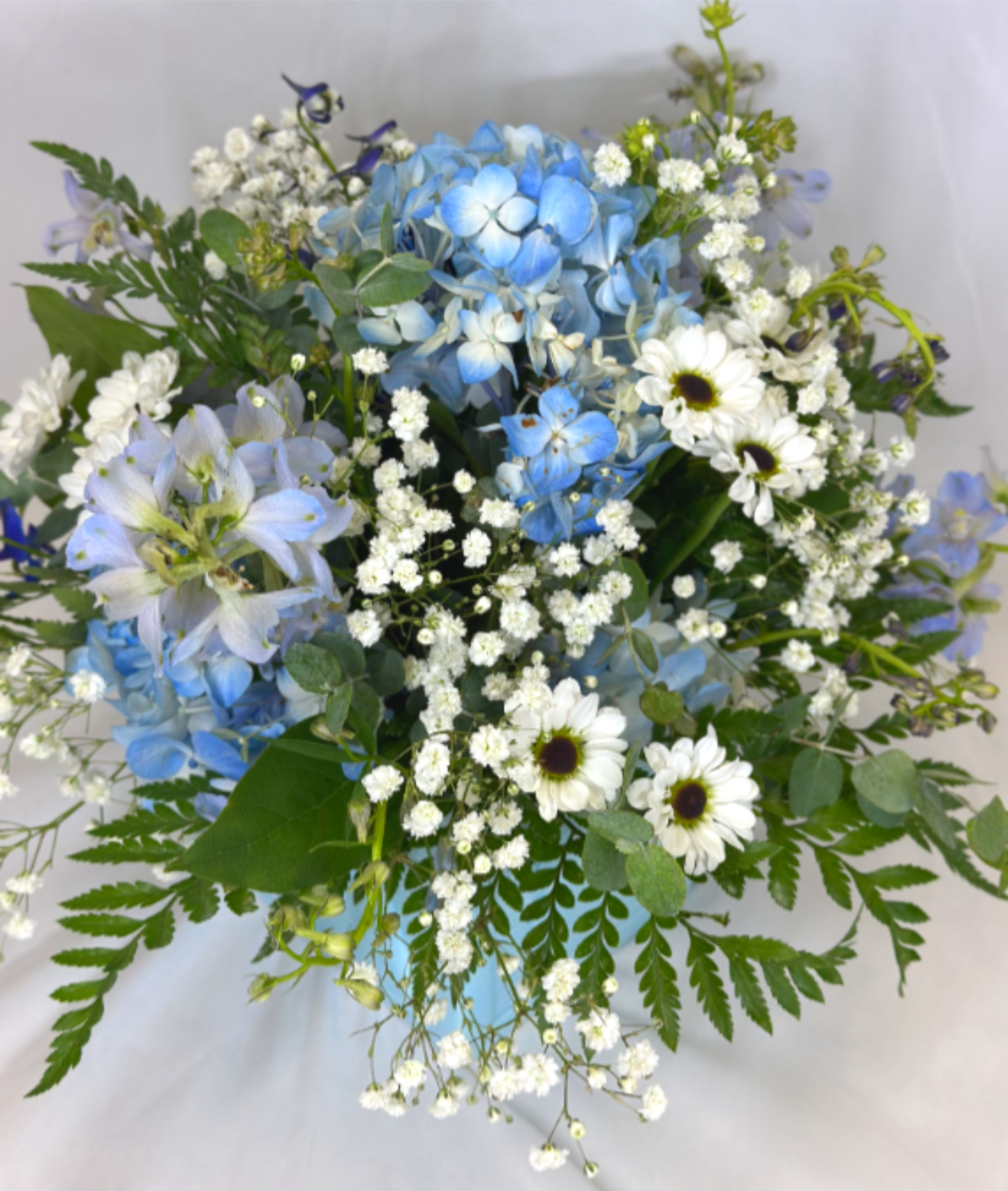 Baby Blue - Baby blue flowers are perfect for so many occasions! This special arrangement is designed exclusively by Leary's Flowers and features a ceramic baby blue cube vase that can be reused over and over. If the featured flowers are unavailable we will design your arrangement using the freshest blooms of equal or greater value