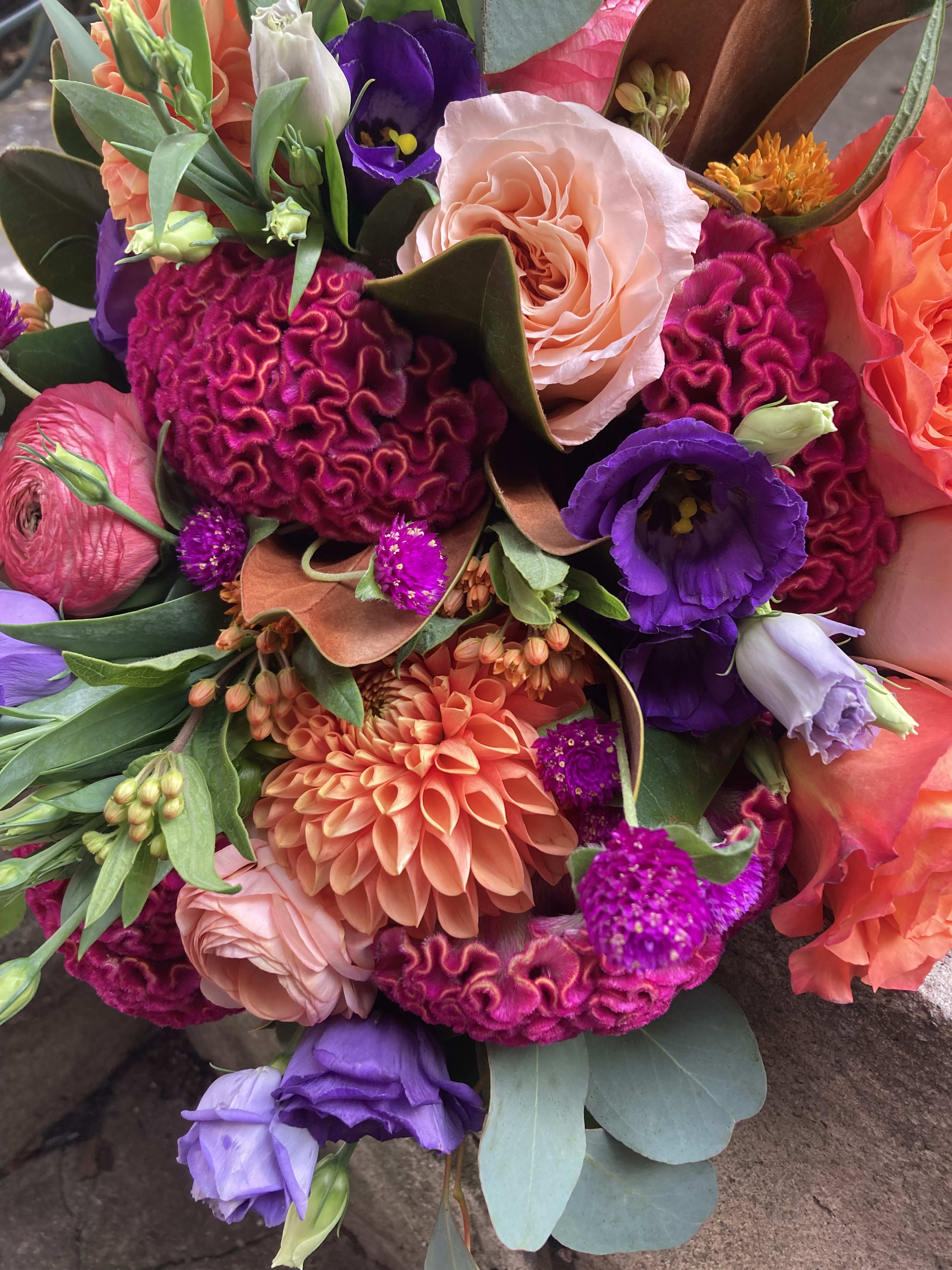 Colorful bouquet with roses, dahlias, and purple blooms