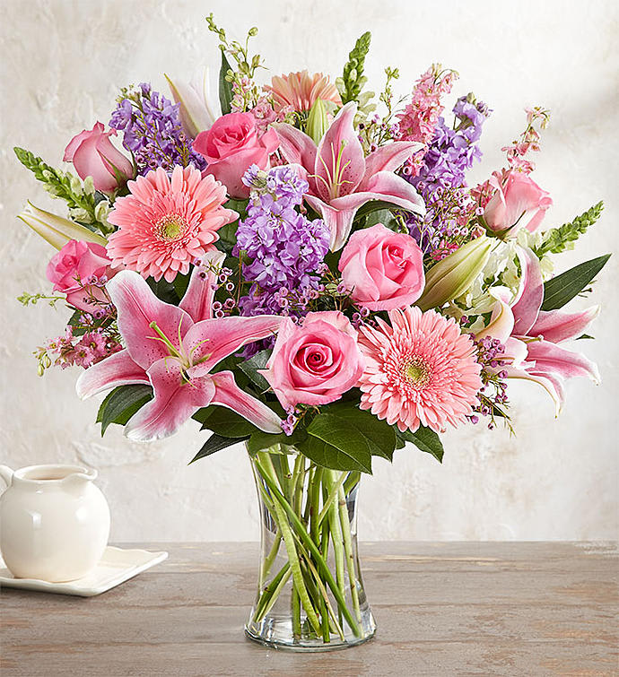 Pink and purple mixed bouquet in a clear glass vase