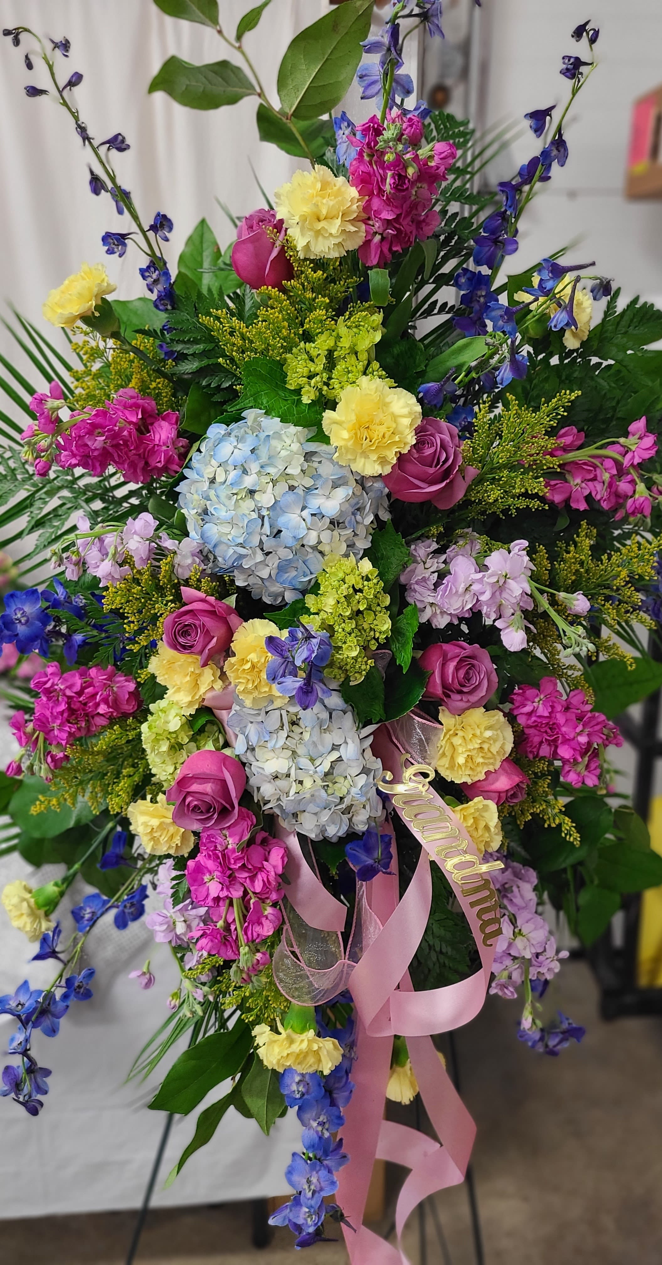 Colorful bouquet with hydrangeas, roses, and blue delphinium