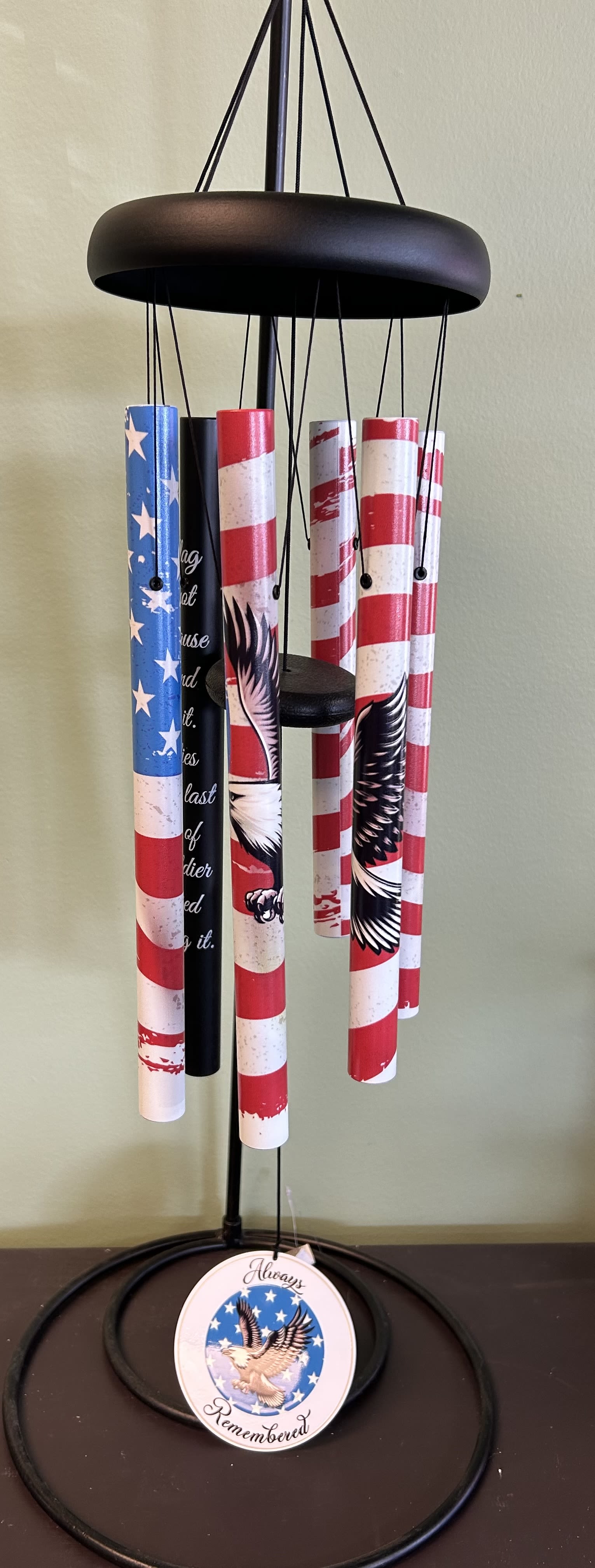 Patriotic wind chime with red, white, and blue tubes and an eagle medallion