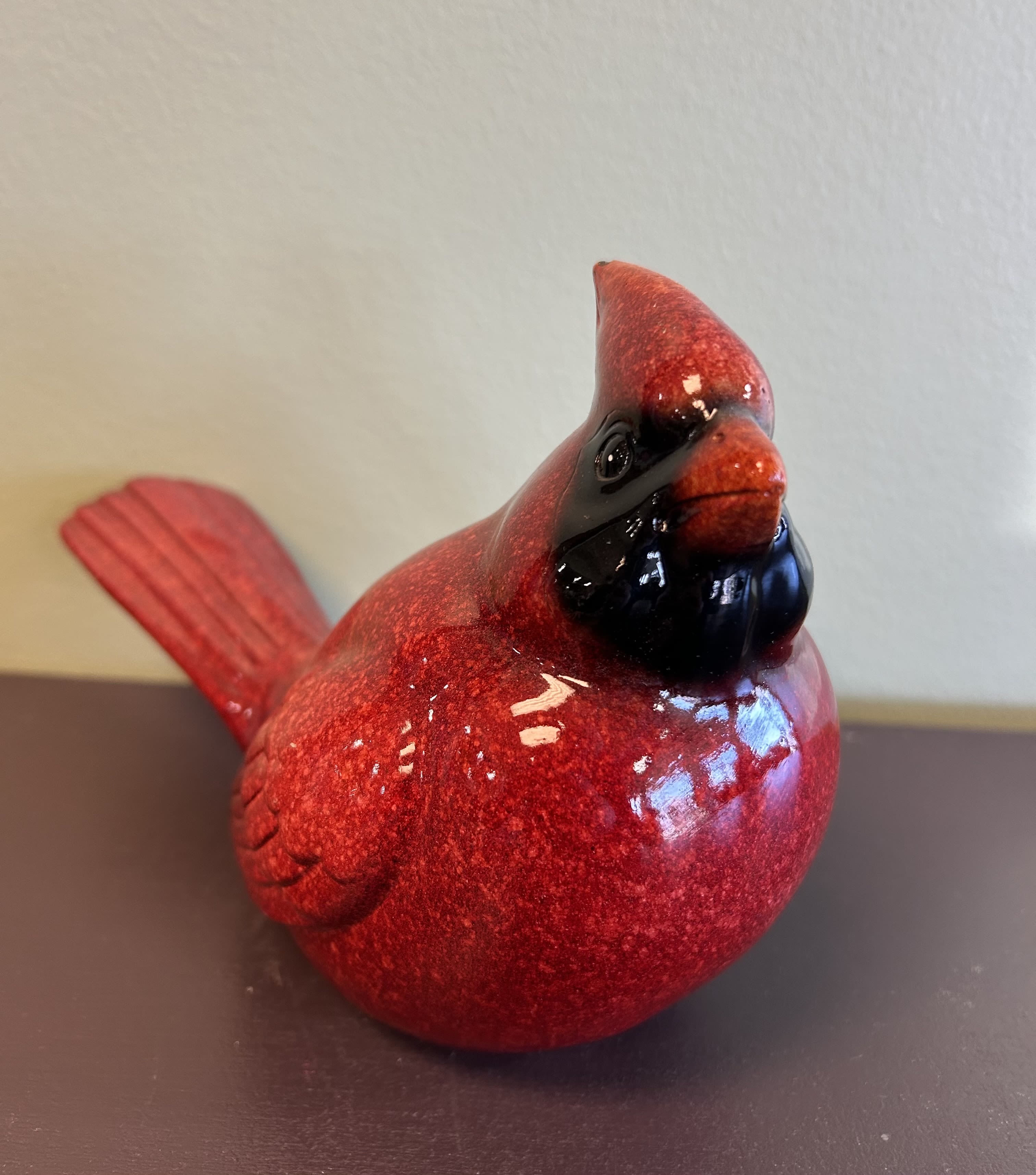 Red decorative bird figurine with a glossy finish