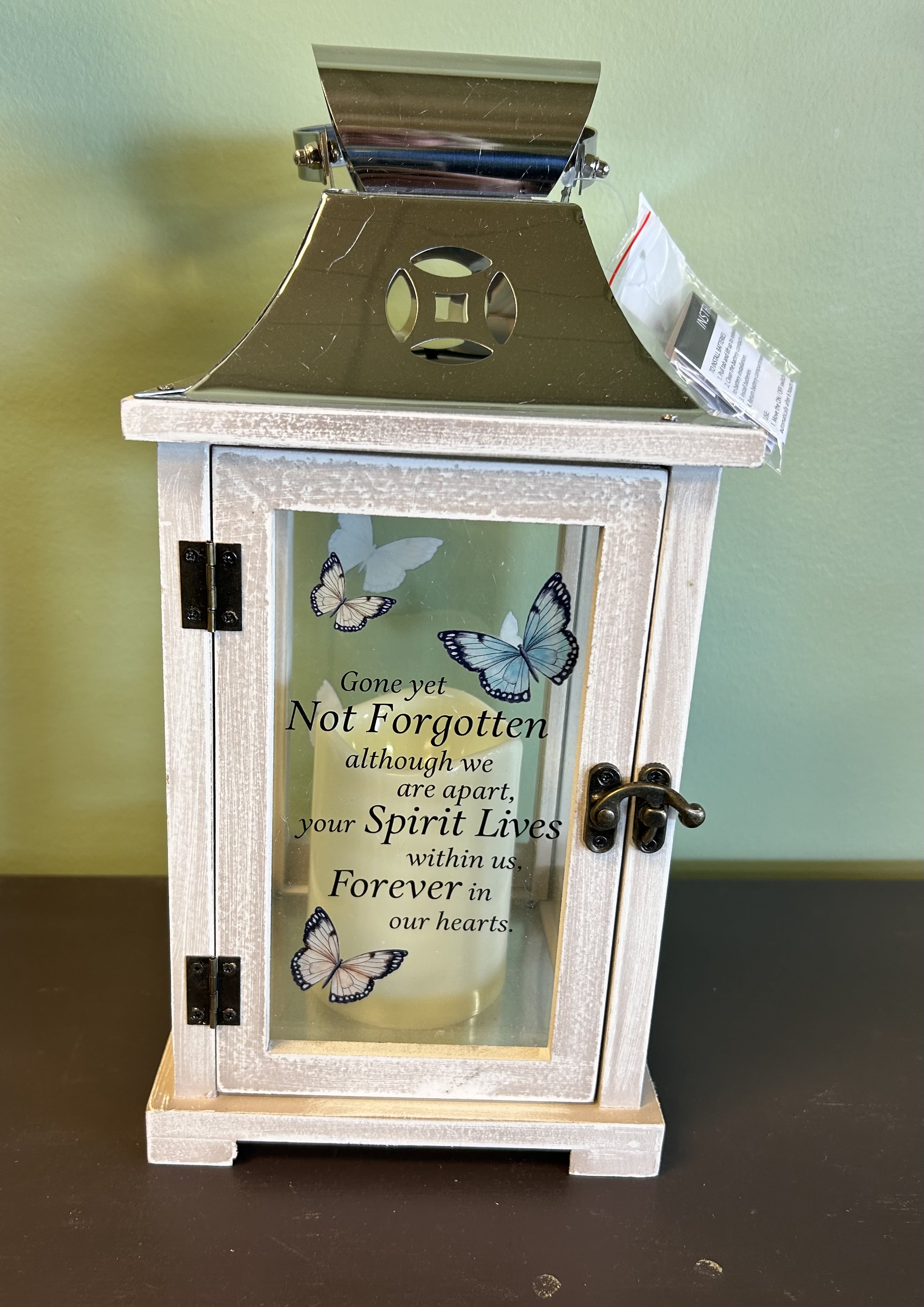 Decorative lantern with a memorial candle and butterfly design