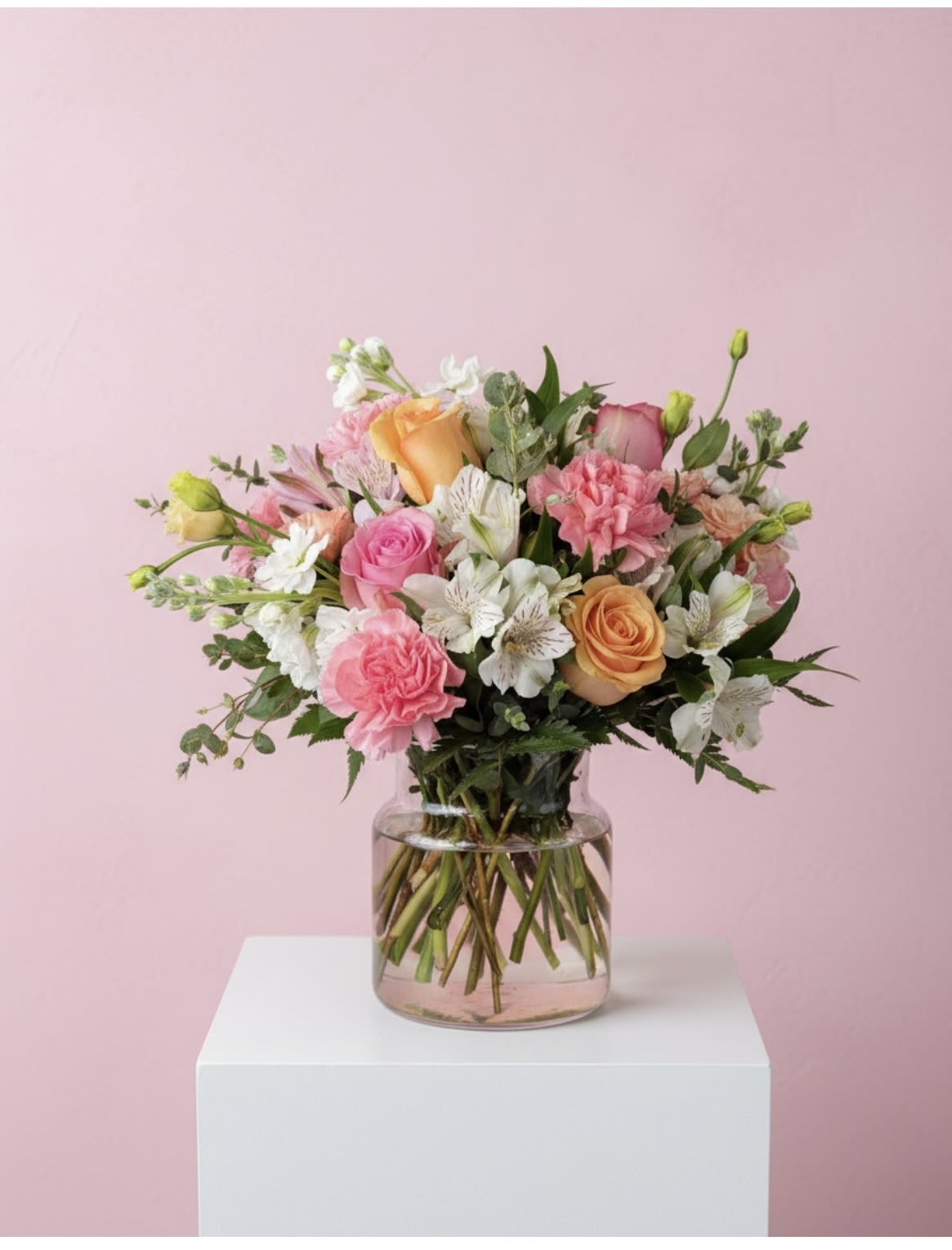 Blushing Blooms - You’ll have them at first blush when they see this stunning bouquet. We’ve gathered a lush mix of blooms in soft shades of pink, peach and white for everyday elegance. Artistically designed in a stylish clear glass cylinder vase, it’s a heartfelt gift for birthdays, anniversaries or just to tickle someone pink