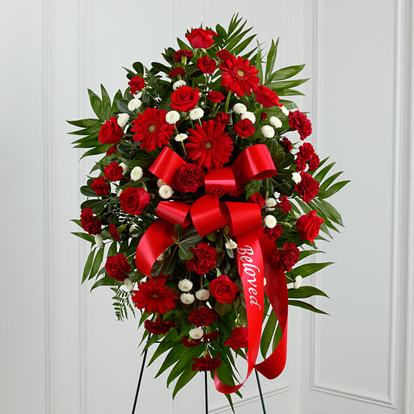 Standing red floral spray with roses, gerbera daisies, and carnations
