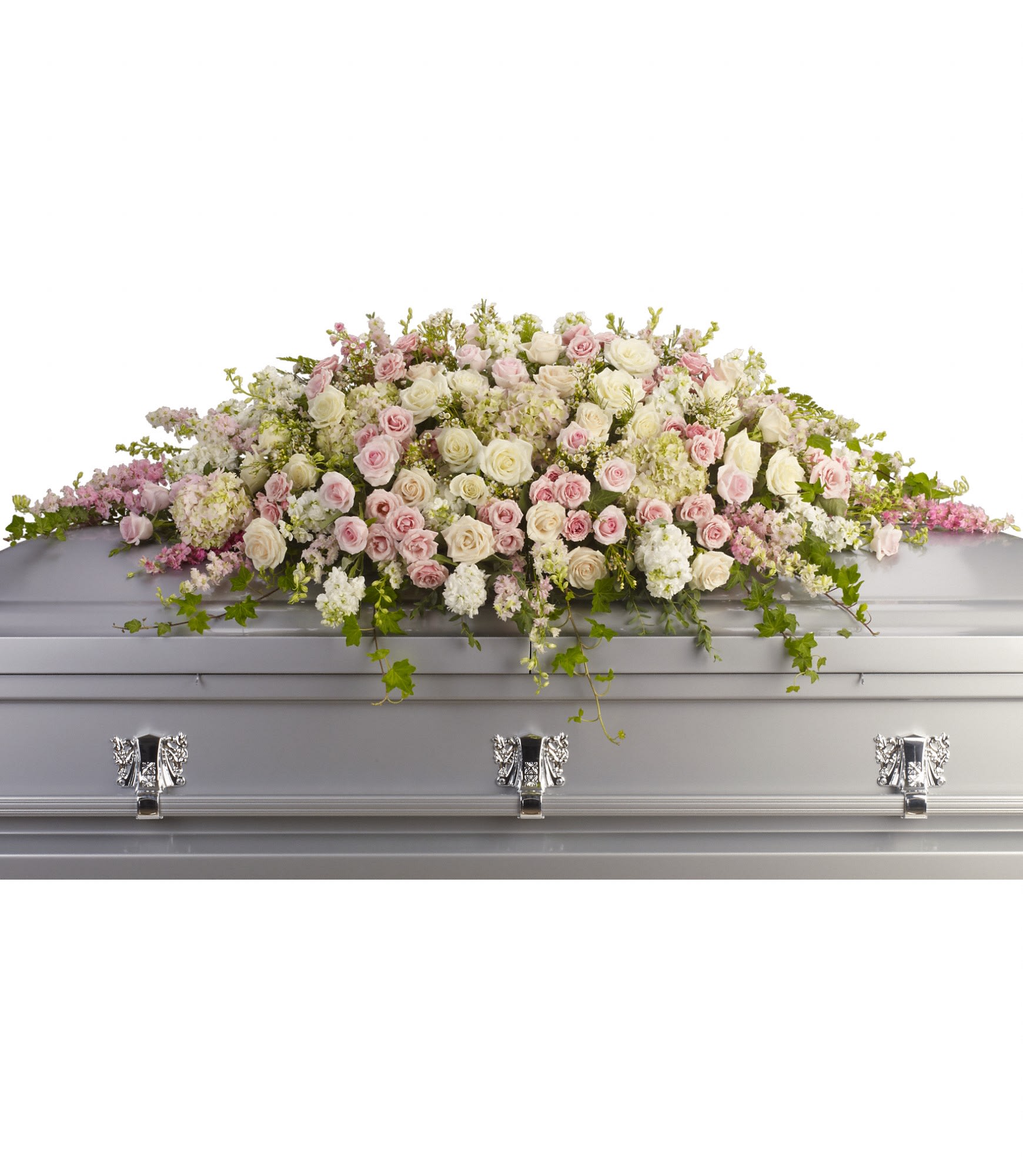 Pastel pink and white floral casket spray on a silver casket