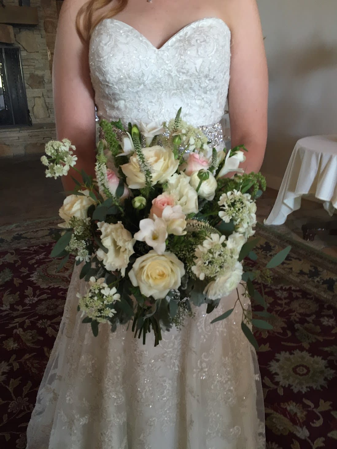 Bride holding a white and blush wedding bouquet