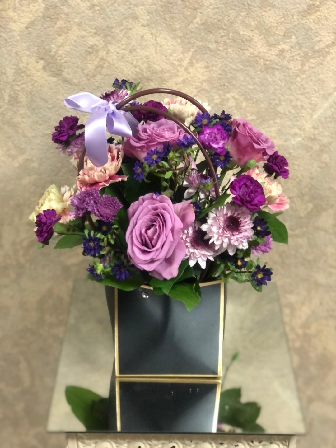 Purple and pink flower basket with a lavender ribbon