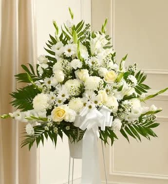 Heartfelt Sympathies White Standing Basket - STAND NOT AVAILABLE Express your heartfelt sympathies with this standing basket, filled with pure and stunning white flowers. Hand-arranged by our expert florists, this touching and tasteful arrangement helps you show your support during a sad and difficult time. Standing basket arrangement of fresh white flowers such as roses, lilies, mums, snapdragons, carnations and more Appropriate for family, friends or business associates to send directly to the funeral home Our florists use only the freshest flowers available, so colors and varieties may vary Large measures approximately 38"H x 38"L without stand Medium measures approximately 32"H x 36"L without stand Small measures approximately 30"H x 34"L without stand Stand may not be available in all areas