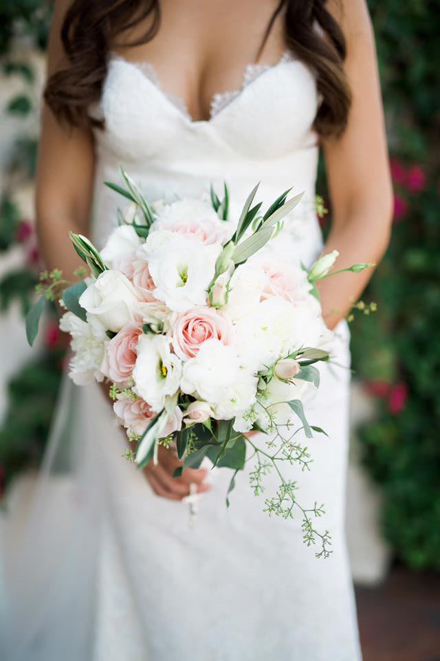 Bride holding a white and blush bouquet