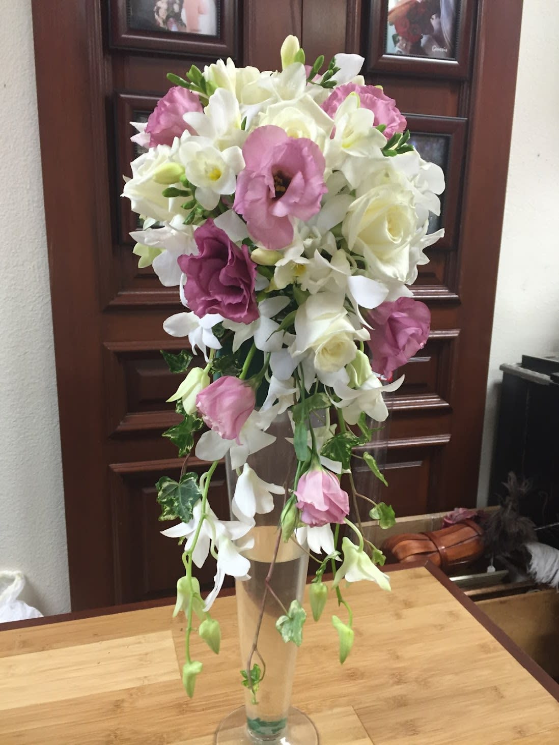 Tall bouquet of white and pink flowers in a clear vase