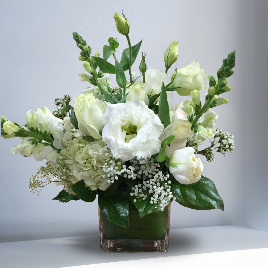 White flowers arranged in a square glass vase