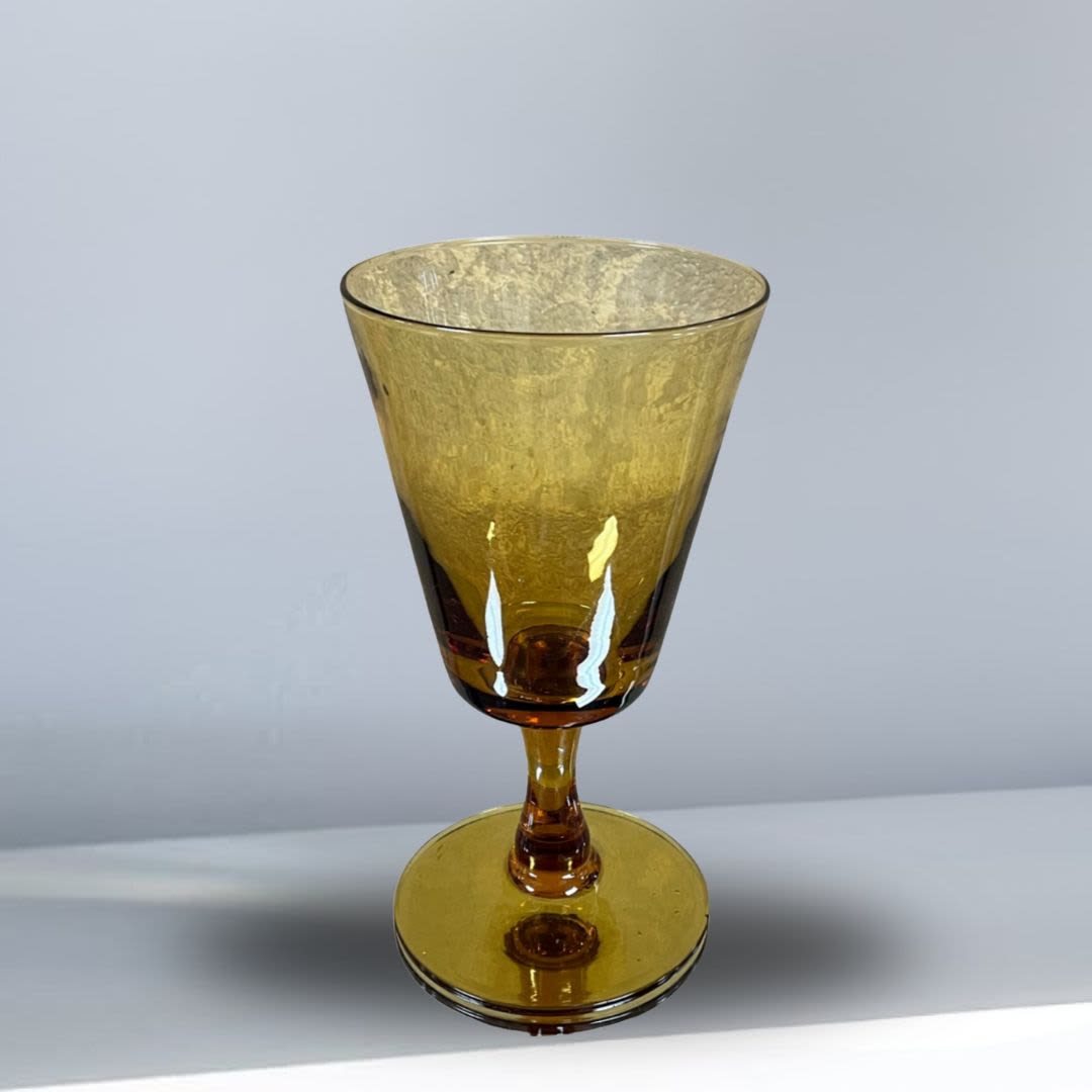 Amber glass goblet with a wide bowl and short stem