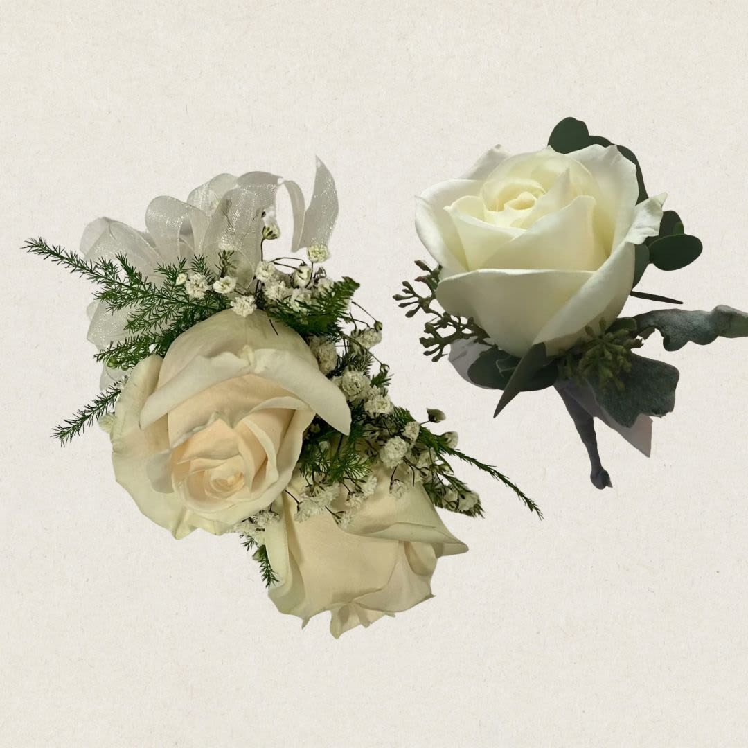Ivory rose corsage with ribbon and matching boutonniere on a light background