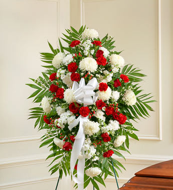 Deepest Sympathies Red &amp; White Standing Spray - With red flowers that symbolize love and white flowers that symbolize reverence, this beautifully crafted standing spray conveys all the love and sympathy you feel deep in your heart. Standing spray arrangement of fresh red and white flowers such as roses, hybrid lilies, carnations and more. Large measures approximately 54"H x 36"L without easel Medium measures approximately 48"H x 36"L without easel Small measures approximately 42"H x 36"L without easel. MUST BE ORDERED 2-3 DAYS IN ADVANCE.