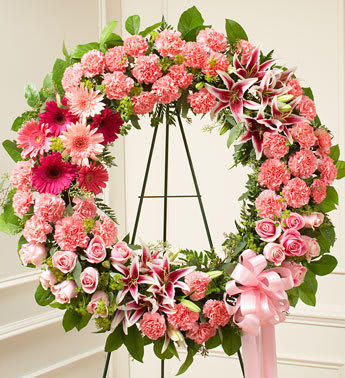 Serene Blessings Standing Wreath - Pink - This pink Standing Wreath perfectly expresses your love and concern at this difficult time. Softly colored flowers such as roses, stargazer lilies, carnations and more are accented by salal and seeded eucalyptus Sent directly to the funeral home by family, friends and business associates Our florists use only the freshest flowers available so colors and assortment may vary Measures approximately 30"H x 30"W without easel.