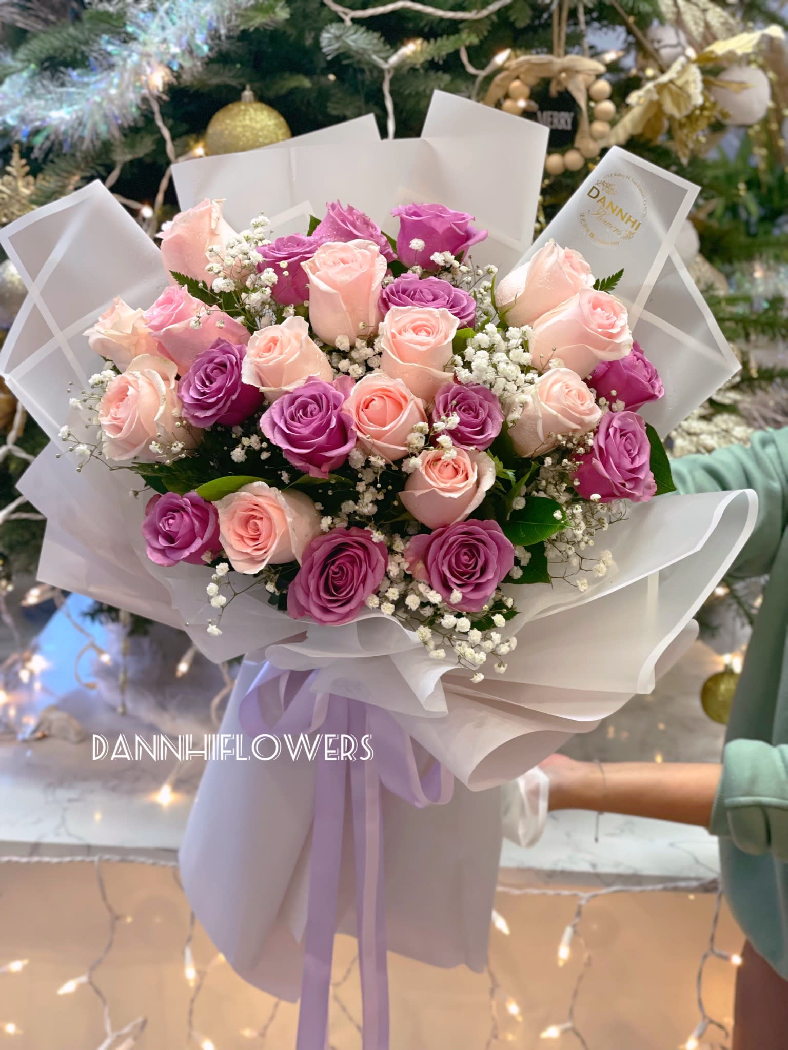 Bouquet of pink and purple roses wrapped in white paper