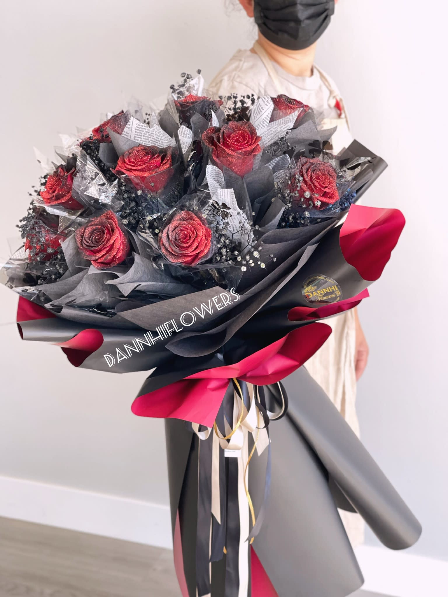 Bouquet of red roses wrapped in black and pink paper