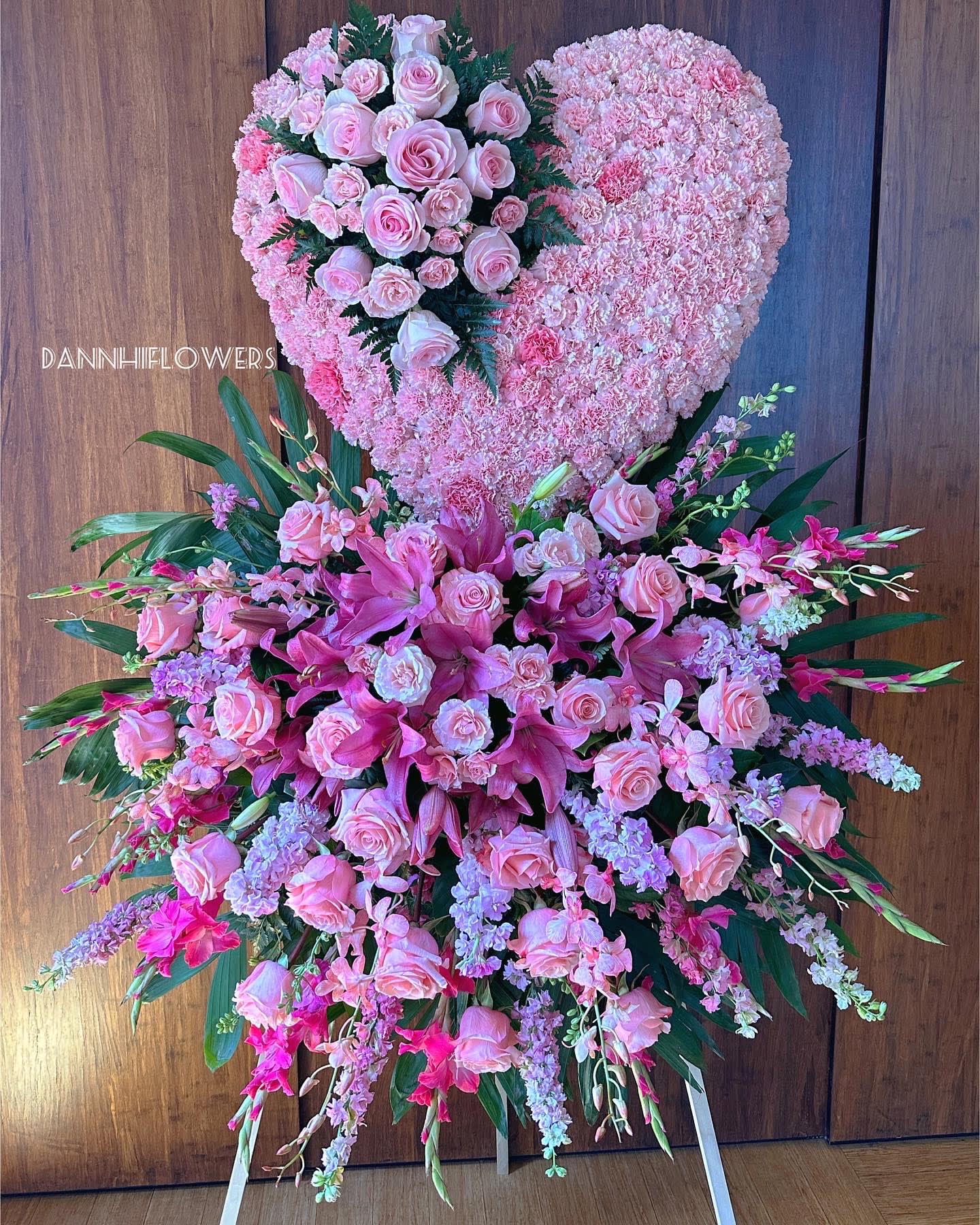 Large pink floral heart and standing spray with roses and lilies