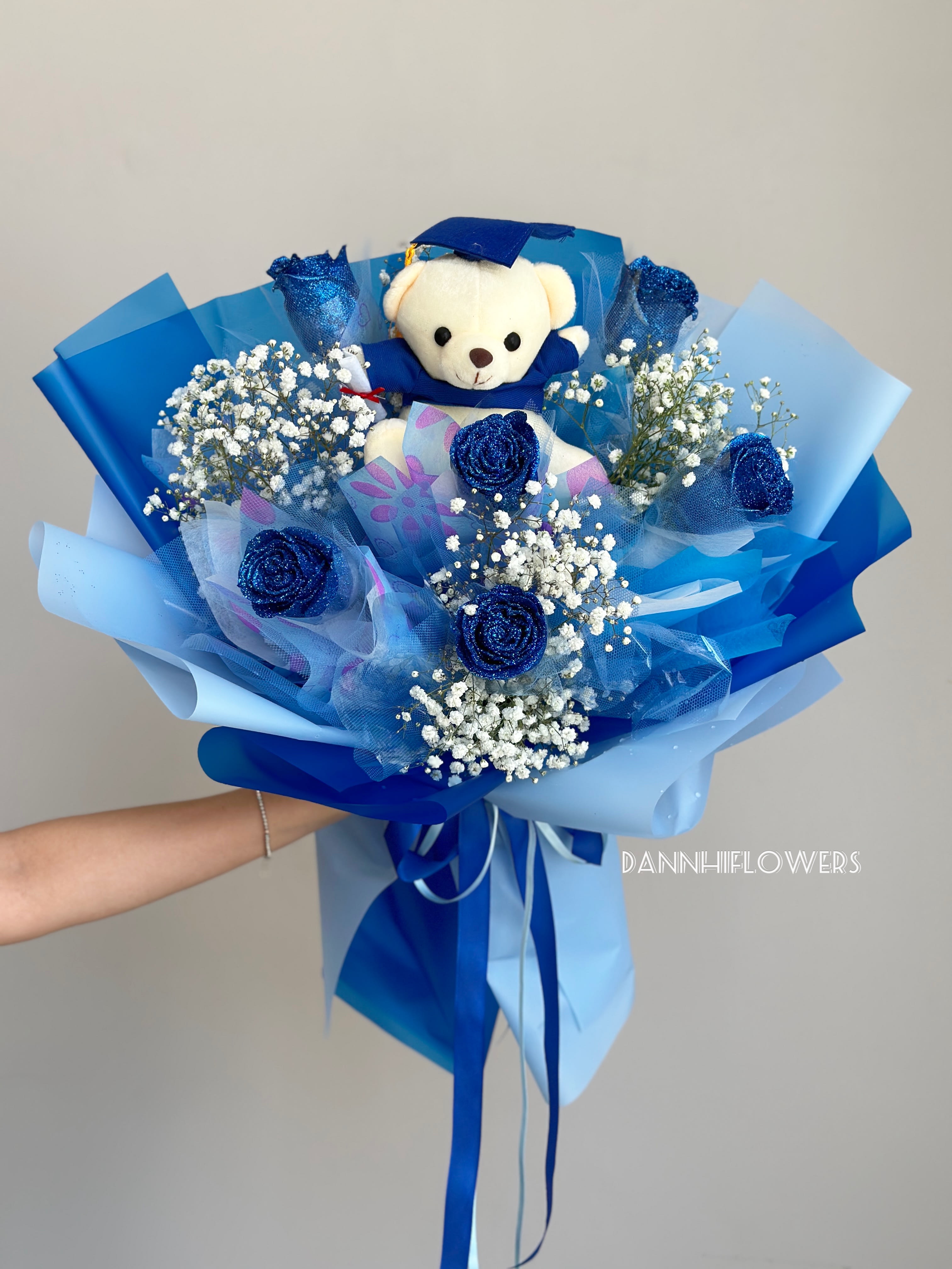 Blue bouquet with a teddy bear and white baby's breath