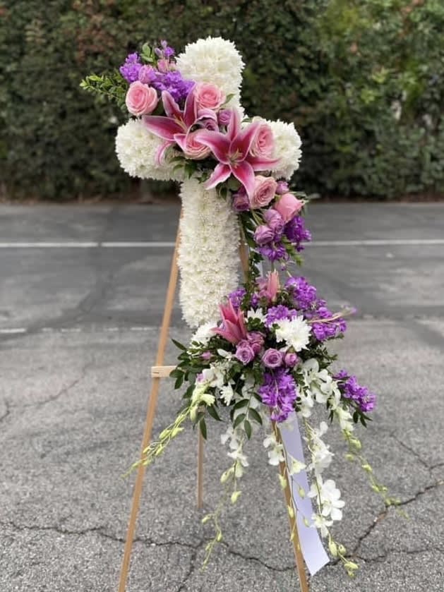 Tall floral standing spray with pink lilies, roses, and white blooms