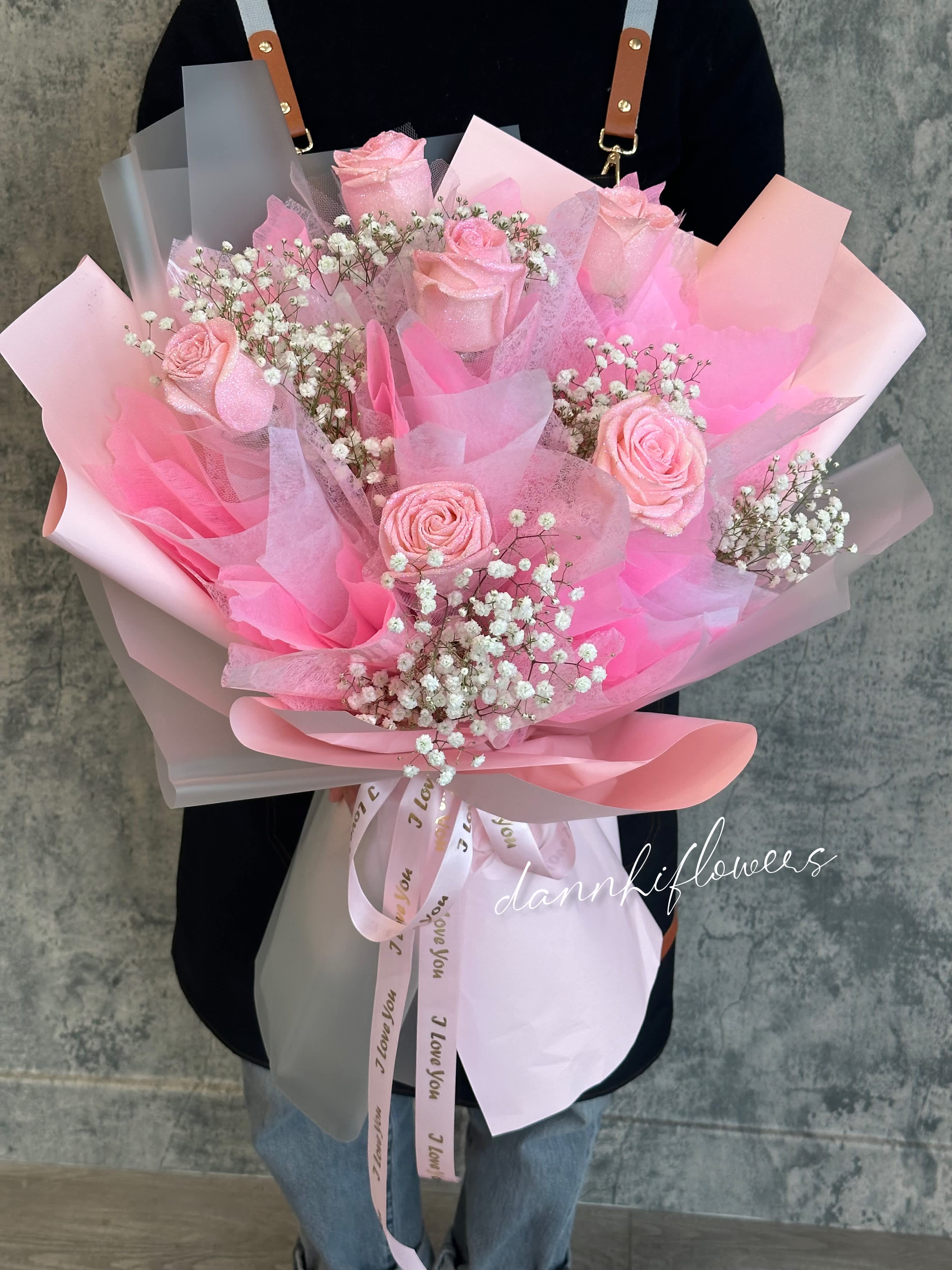 Pink rose bouquet with baby's breath in layered pastel wrapping