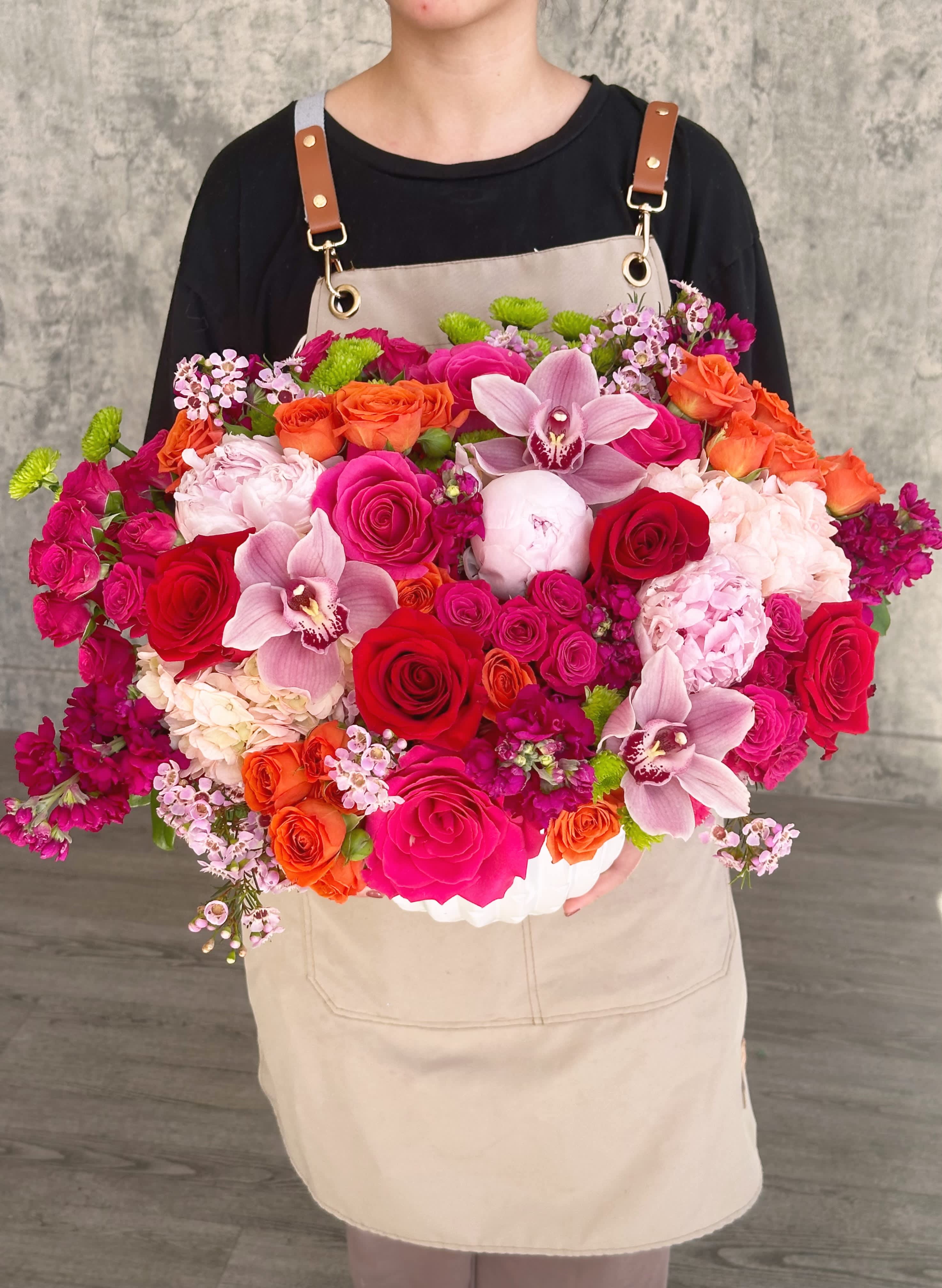 Large mixed bouquet with roses, orchids, and pink hydrangeas