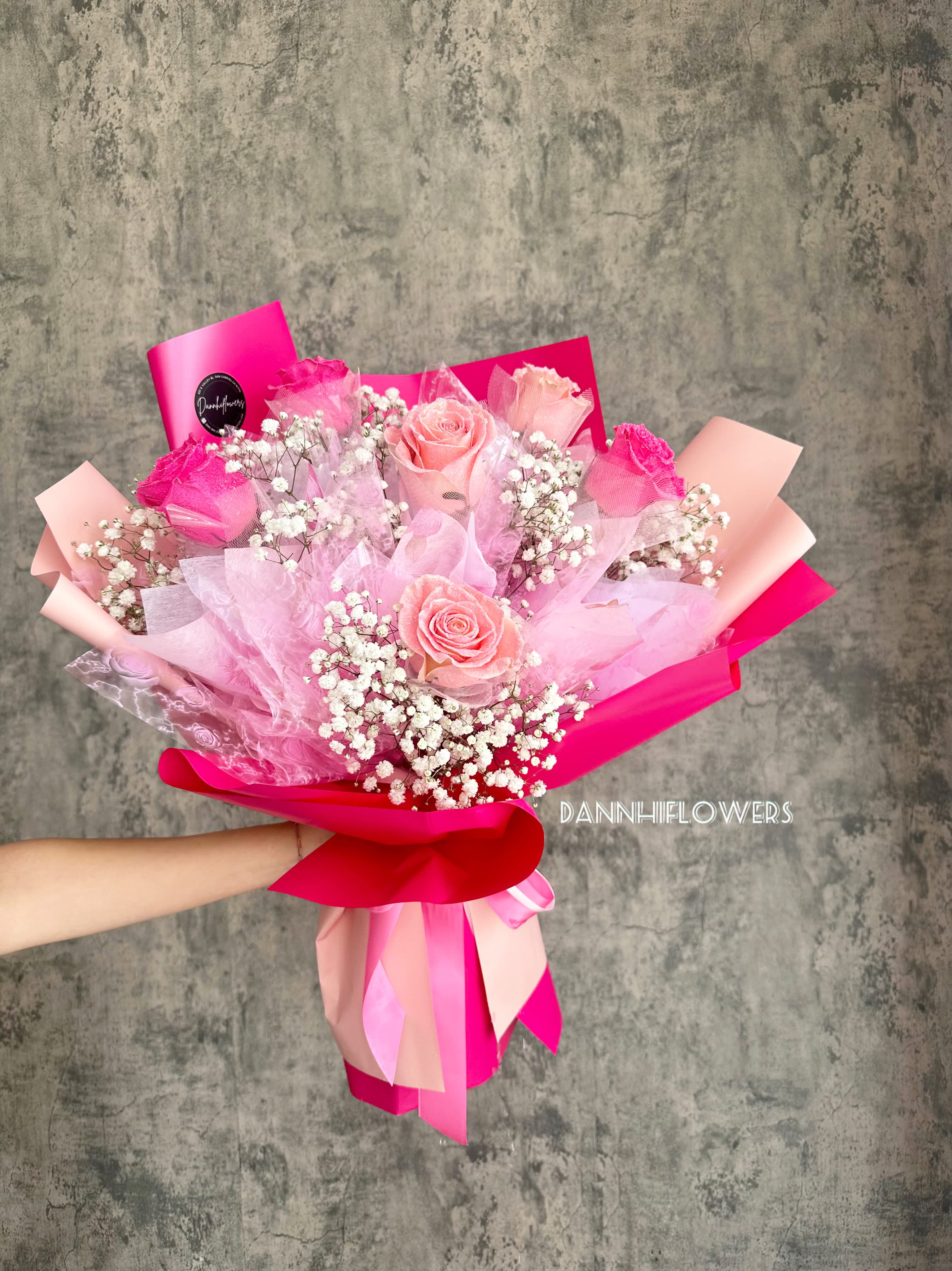 Pink rose bouquet with baby's breath and bright ribbon wrapping