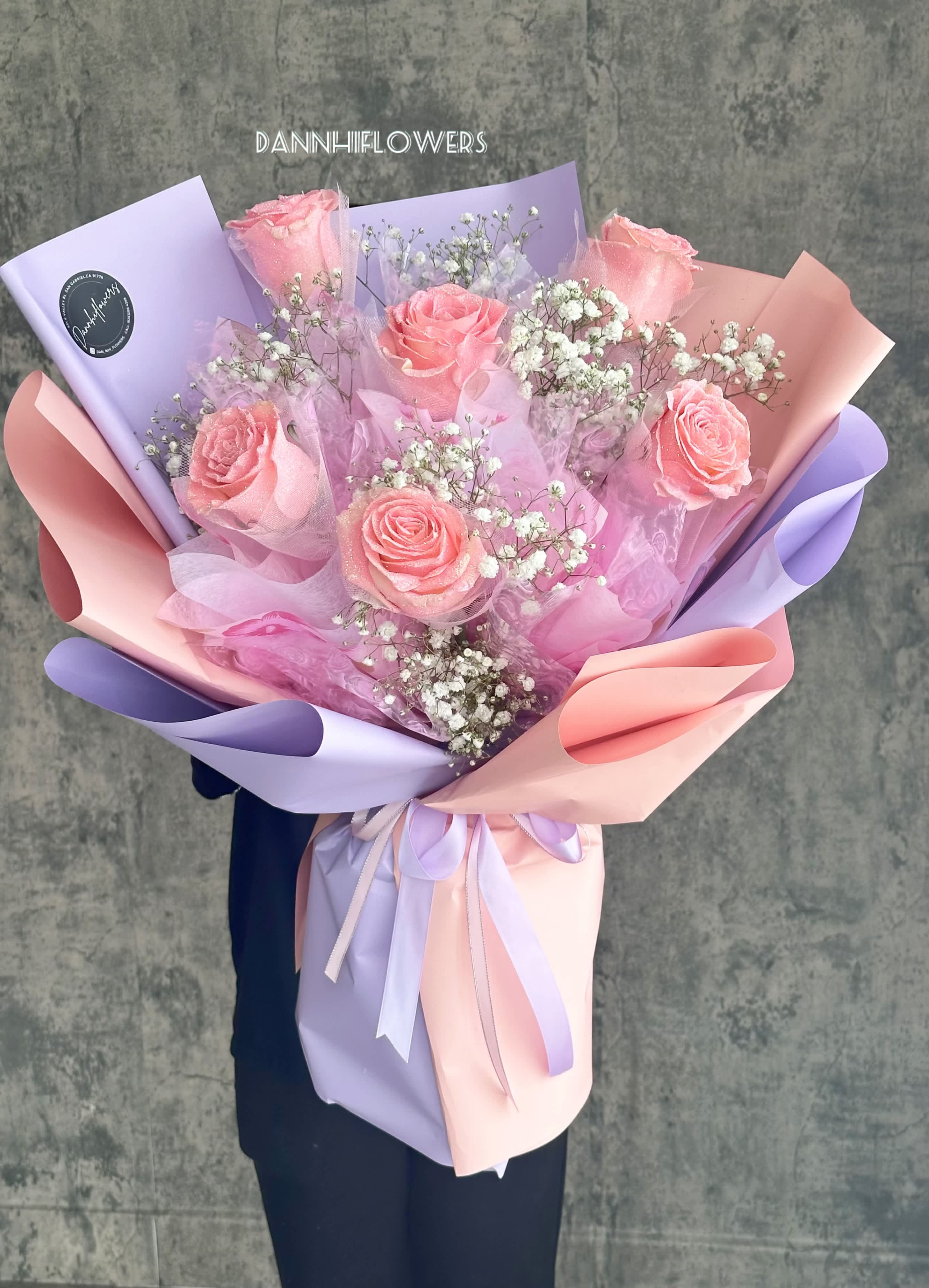 Pink roses with baby's breath in pastel lavender and peach wrapping
