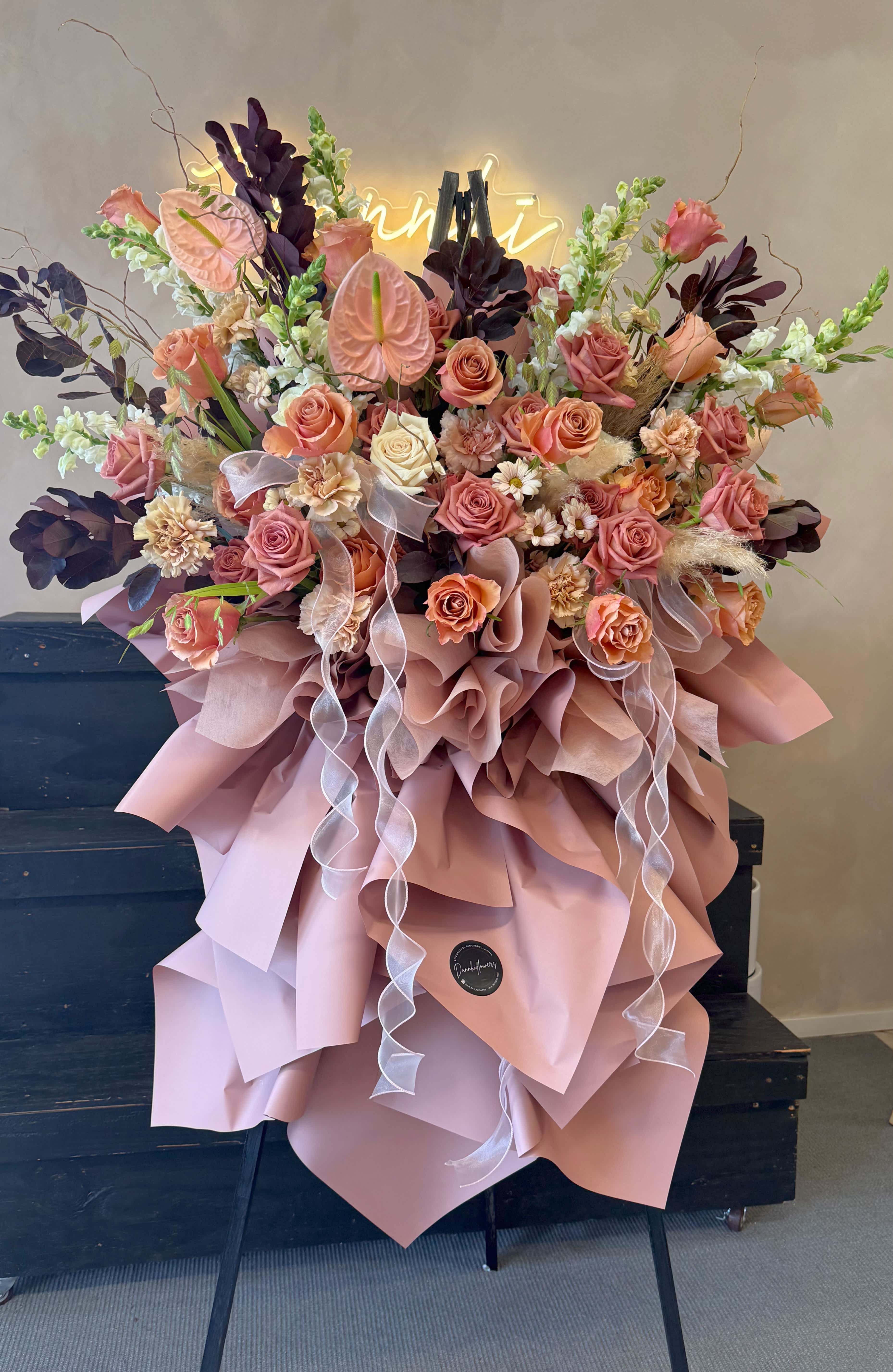 Large bouquet of peach and pink roses with ribbon and wrapping